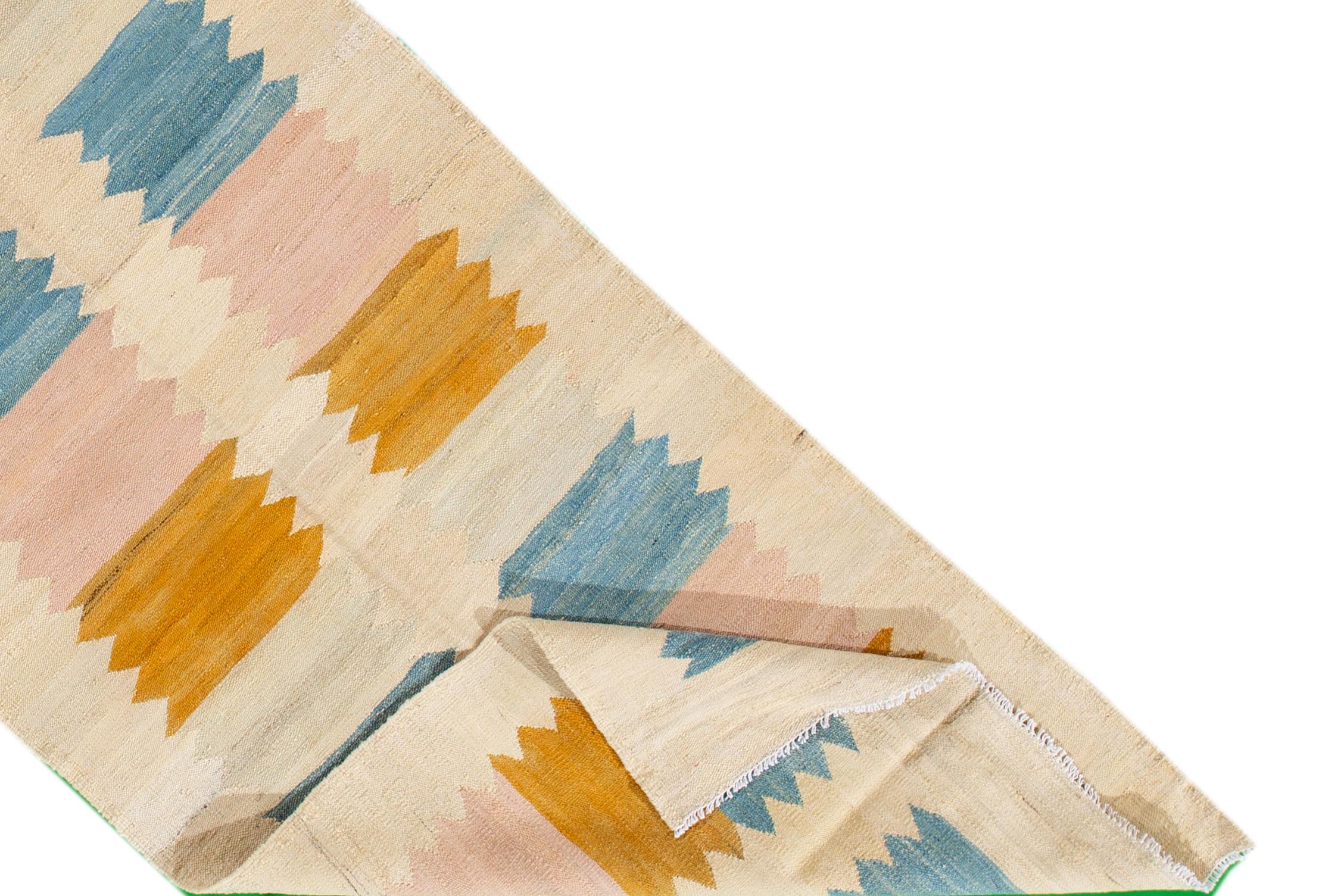 A hand-knotted modern Kilim rug with a geometric design. This rug measures 2'9