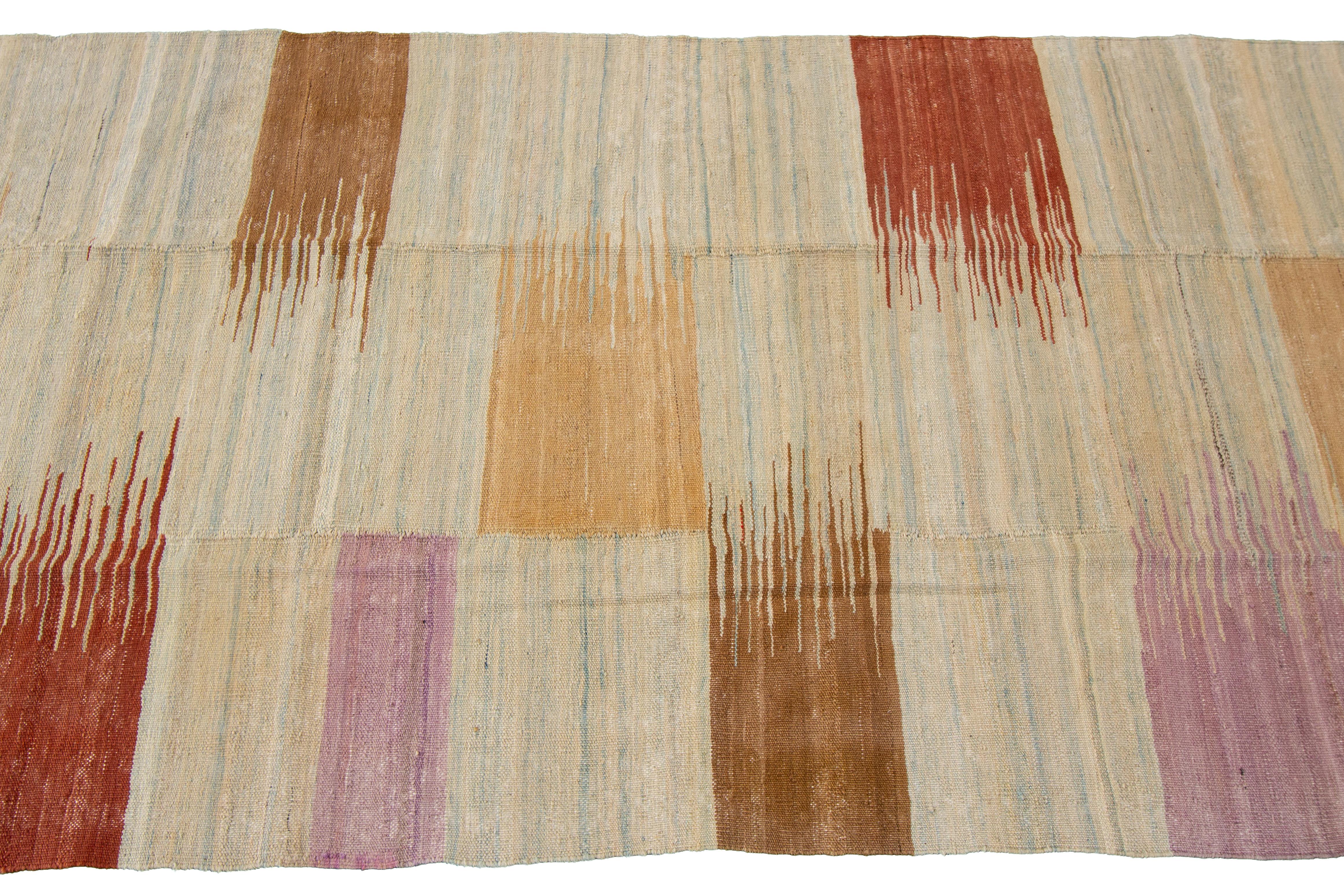 A hand-knotted modern Kilim rug with a geometric design. This rug measures 3'3