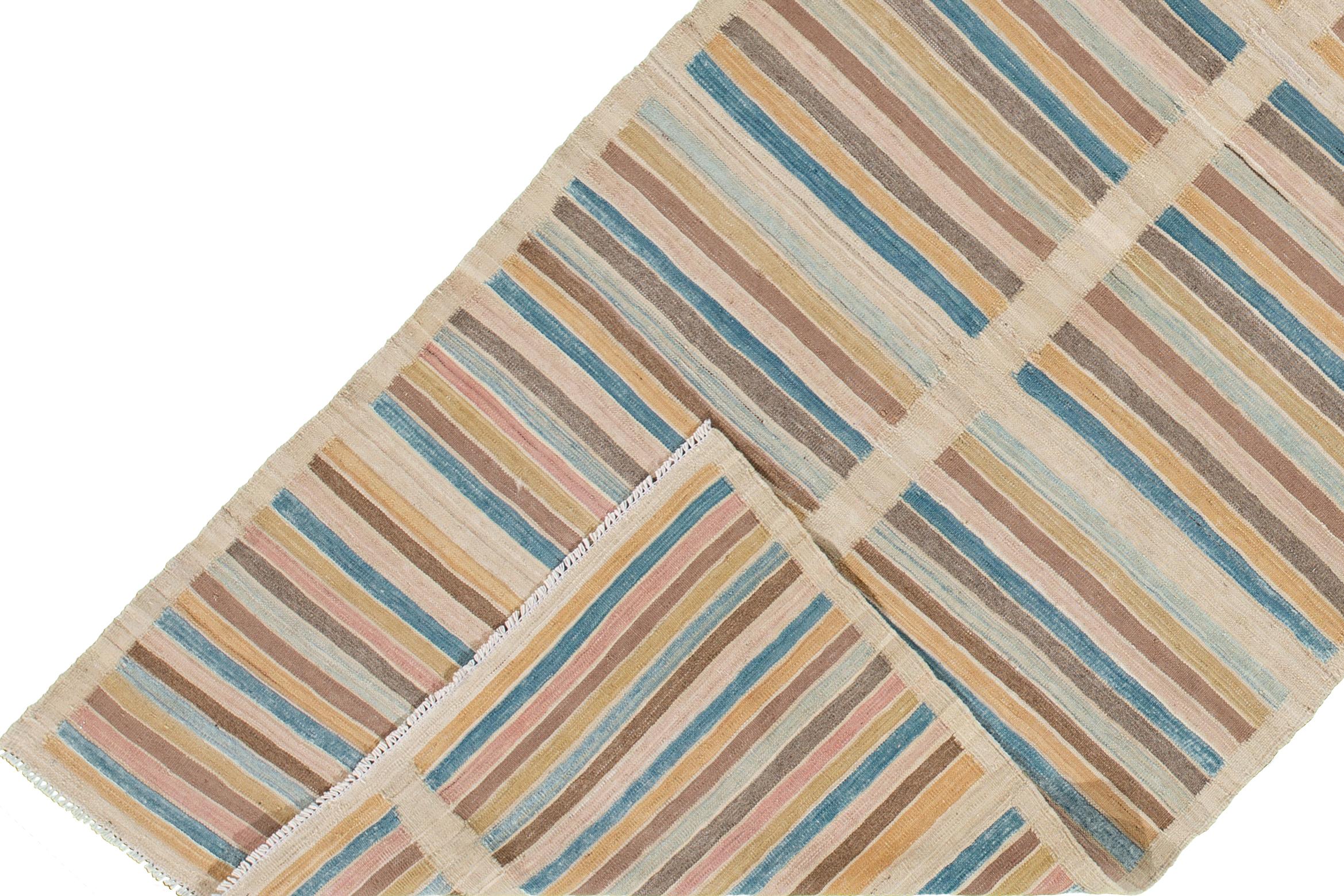 A hand-knotted modern Kilim rug with a linear pattern design. This rug measures 3'6