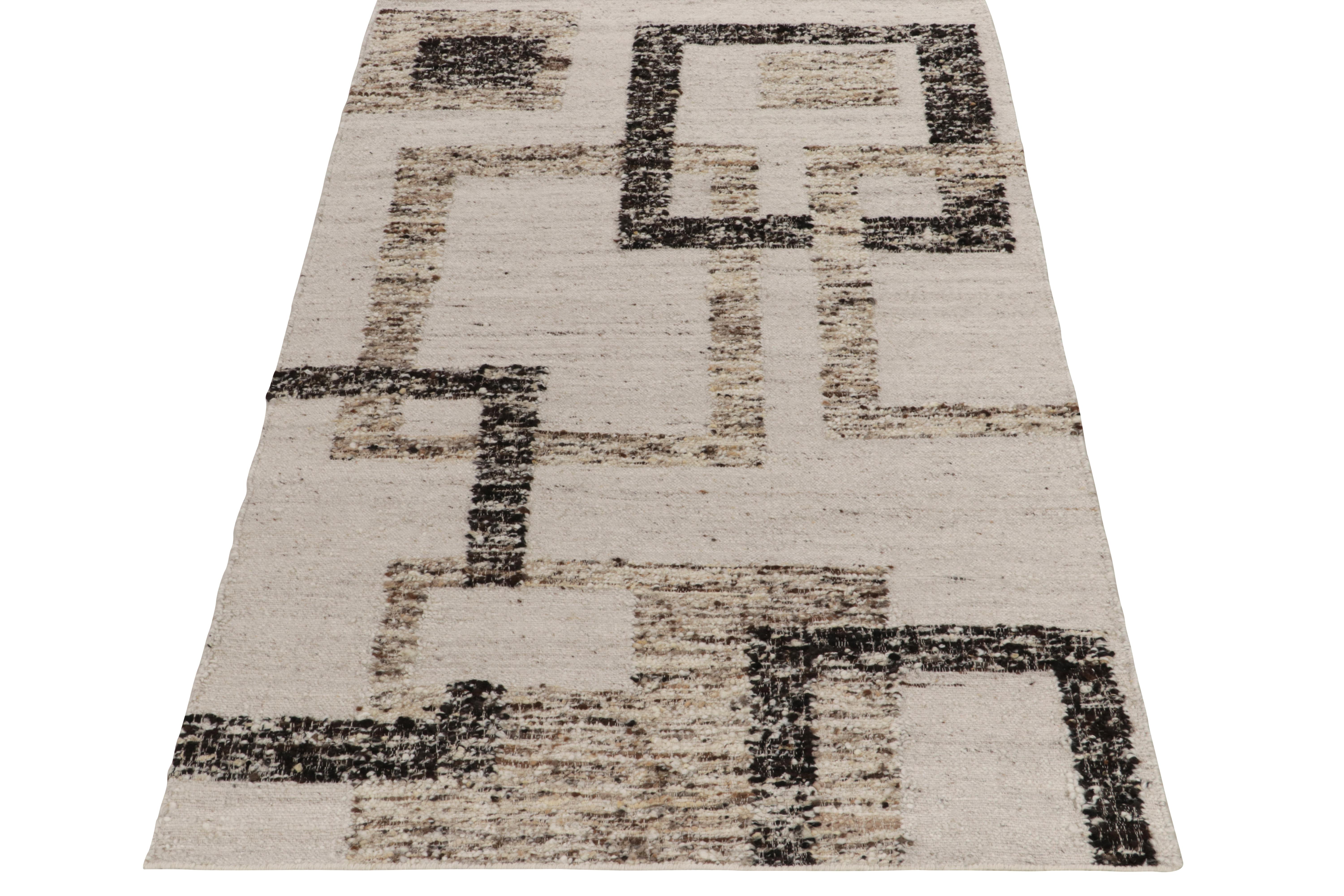 A bold marriage of Art Deco style and innovative texture, Rug & Kilim unveils this contemporary flat weave technique. The 5x8 Kilim rug features overlapping geometric patterns in crisp white, beige-brown and black—a unique play of positive-negative