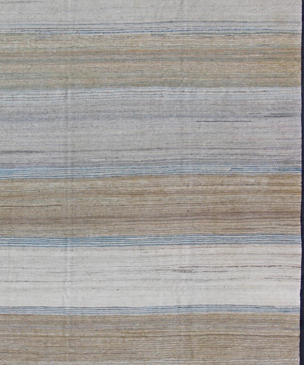 Keivan Woven Arts-Flat-weave Kilim rug with stripes with modern design in shades of blue, taupe gray and cream, rug afg-29515, country of origin / type: Afghanistan / Kilim

This playful piece features a Classic stripe design that evokes casual and