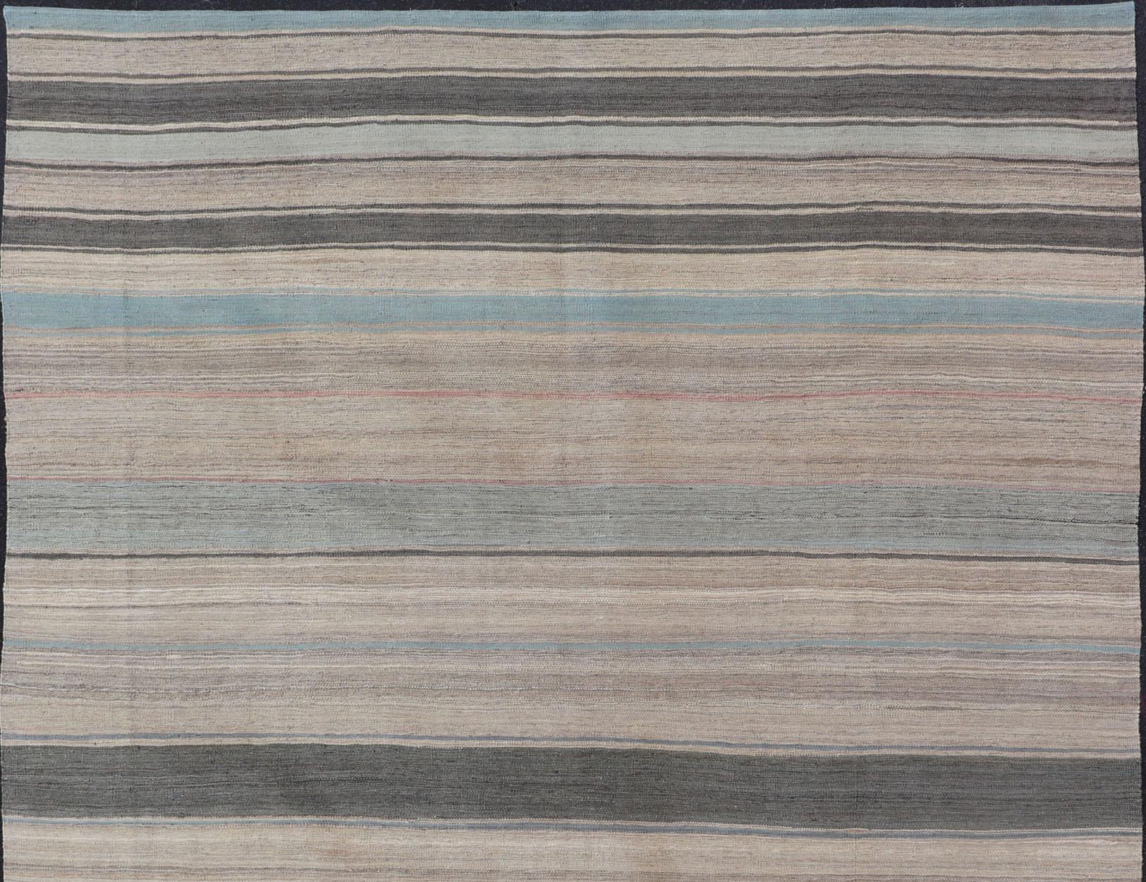 Flat-weave Kilim rug with stripes with modern design in shades of blue, taupe gray and cream, rug AFG-125, Keivan Woven Arts country of origin / type: Afghanistan / Kilim

This playful piece features a Classic stripe design that evokes casual and
