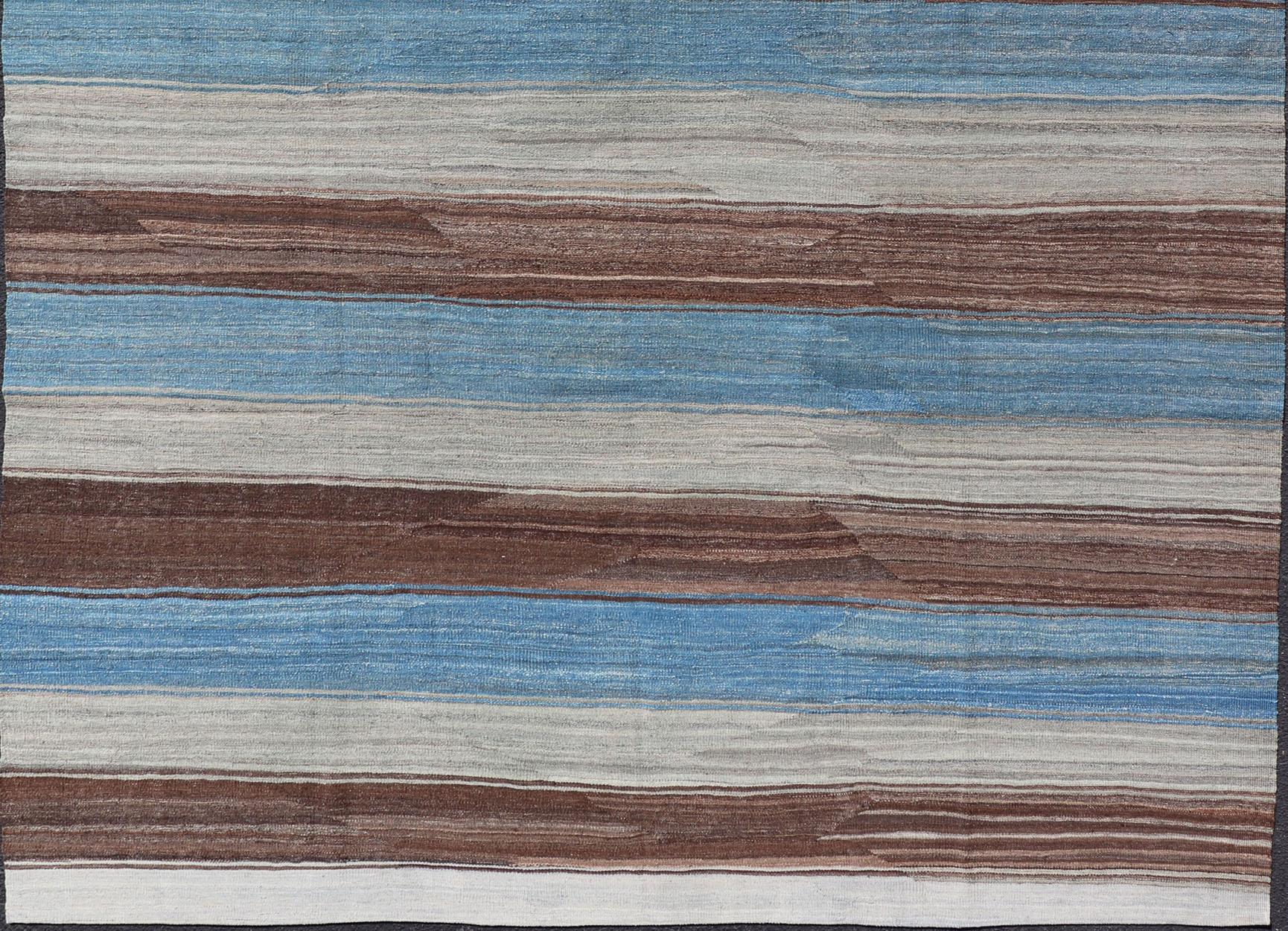 Flat-weave Kilim rug with stripes with modern design in shades of blue, gray, brown and cream, rug AFG-27629, country of origin / type: Afghanistan / Kilim, Stripe Kilim, Stripe design 

This beautiful piece features a Classic stripe design that