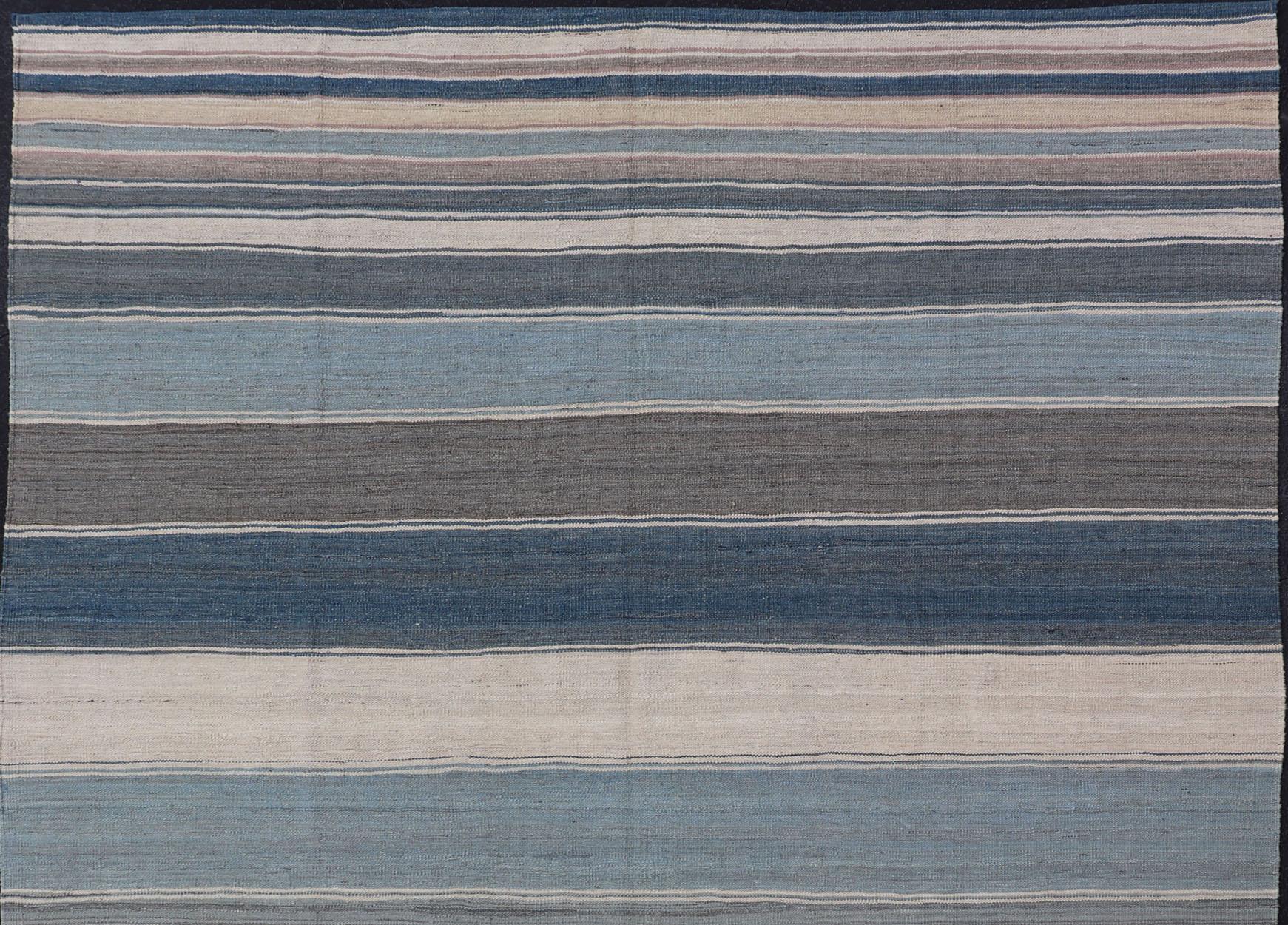 Flat-weave Kilim rug with stripes with modern design in shades of blue, gray, brown and cream, Keivan Woven Arts / rug AFG-156, country of origin / type: Afghanistan / Kilim, Stripe Kilim, Stripe design 

This beautiful piece features a Classic