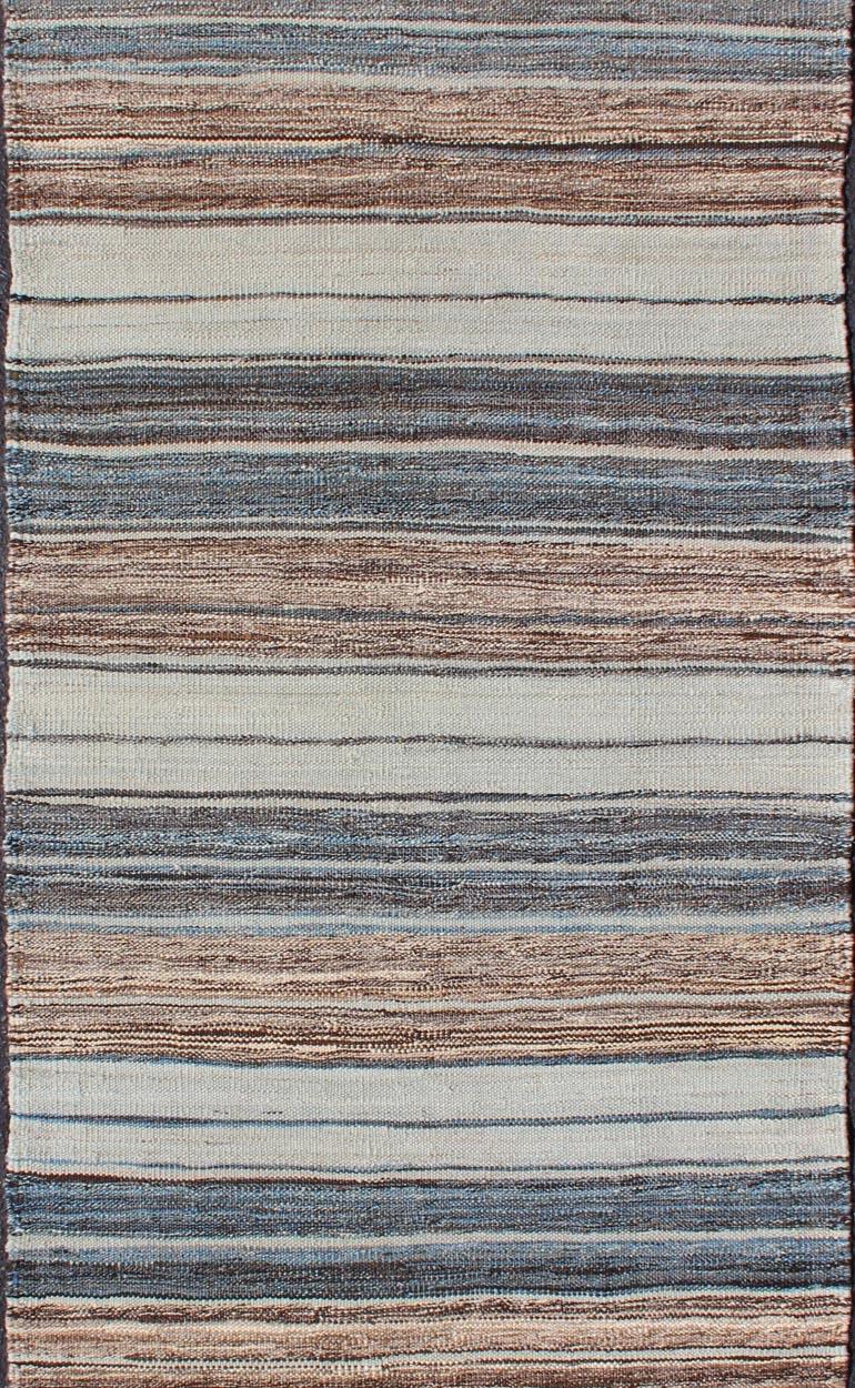 Flat-weave Kilim rug with stripes with modern design in shades of blue, taupe, brown and cream, rug AFG-27742, country of origin / type: Afghanistan / Kilim

This playful piece features a Classic stripe design that evokes casual and easy vibes.