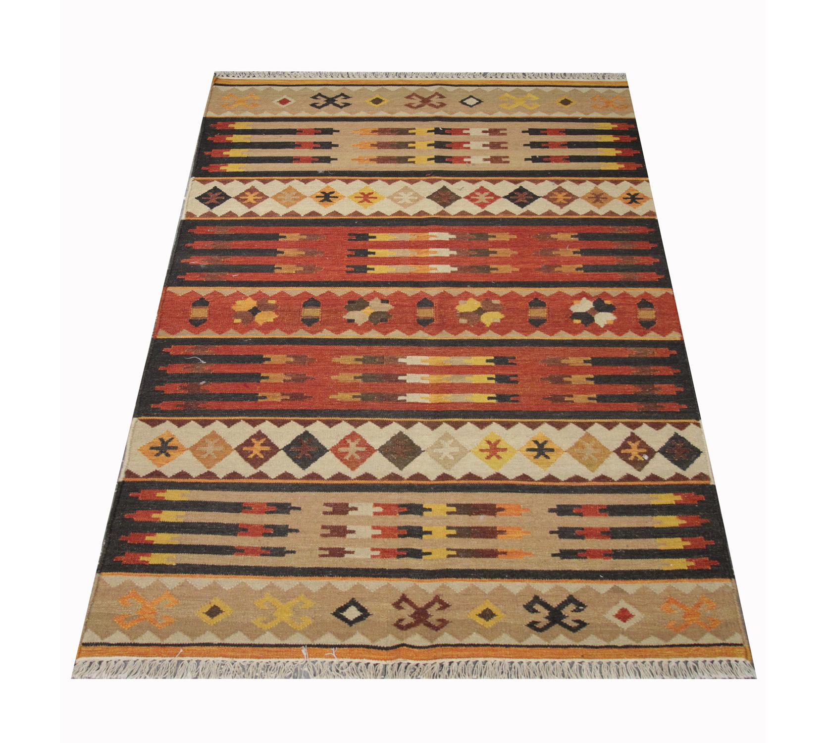 This modern wool kilim was woven by hand in India in the early 21st century. The design features symmetrical geometrical patterns that have been woven in an array of rustic colours, including brown, beige, rust and mustard. The colour palette and