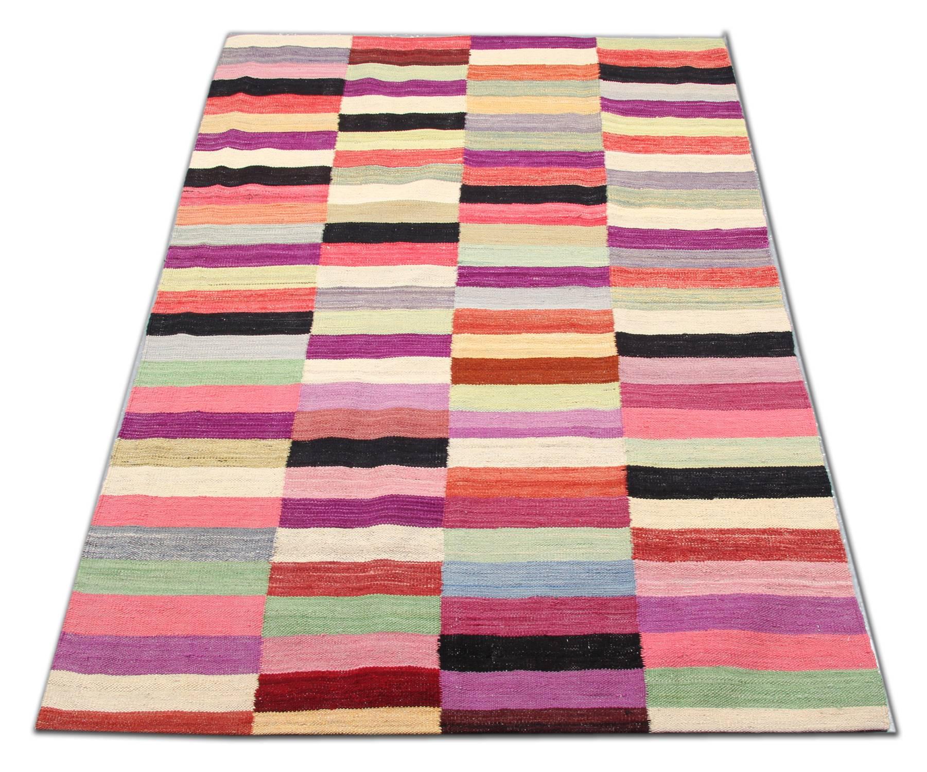 These striped wool rugs derive from Afghanistan. It is an entirely handwoven rug with the best wool and cotton. Only organic dyes have been used for the production of this flat-woven rug. This striped rug shows a varied palette, including light
