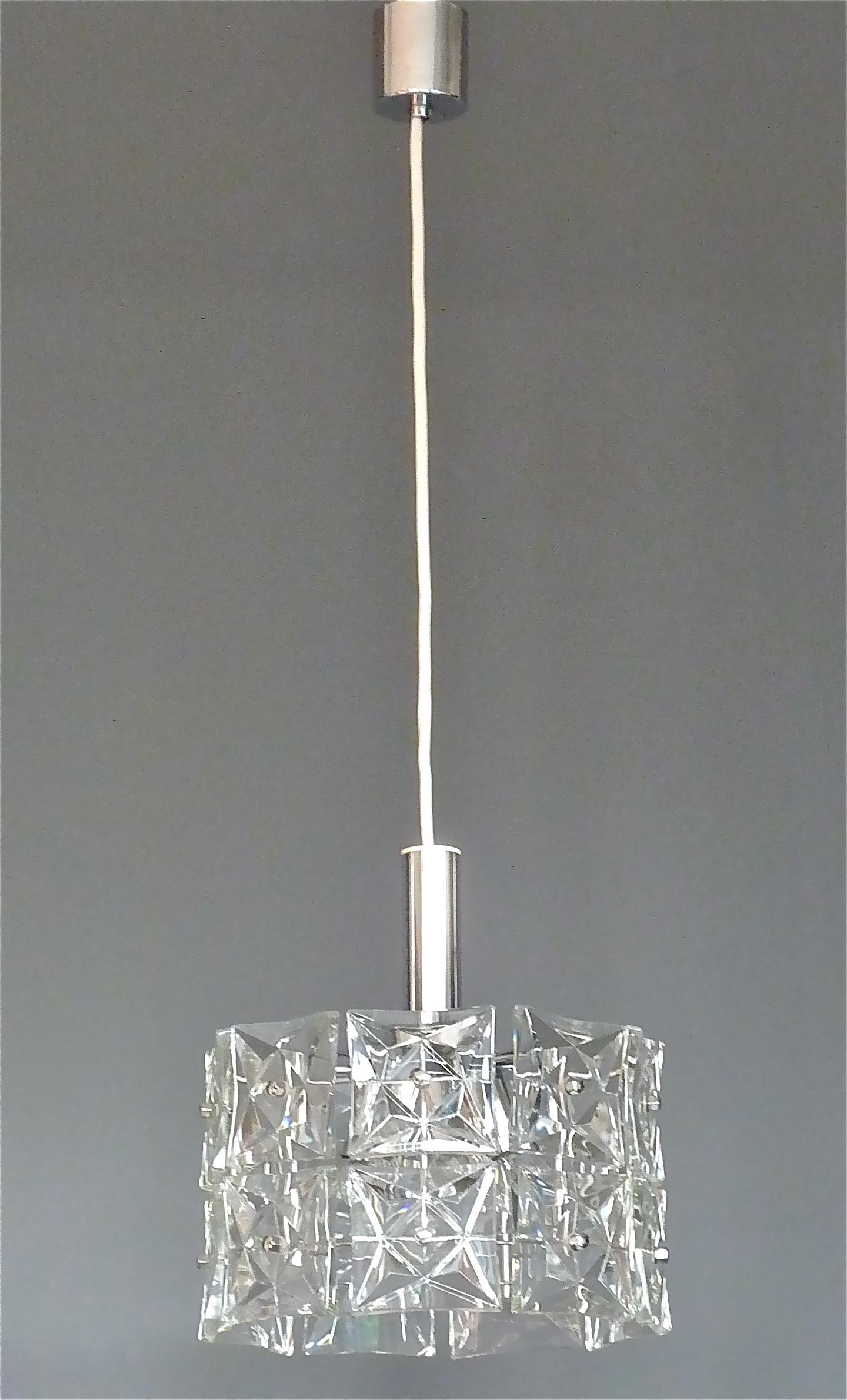 Modernist Space Age two tier chandelier by Kinkeldey, Germany, circa 1960-1970. It has 18 sparkling square faceted crystal glass panels, each 10 x 10 cm / 3.94 x 3.94 inches tall and wide mounted on a chrome brass metal fixture. It takes six E14