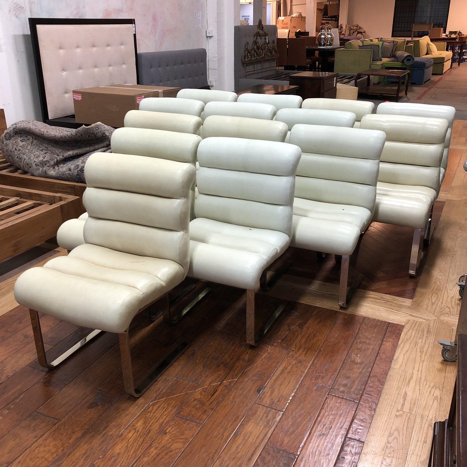 Set of fourteen Laguna cantilever dining chairs. Designed by Frank Mariani for Pace Industries, the set is incredibly comfortable while remaining oh so mod. The chairs retain their original creamy bonded leather with some wear. Heavy chrome frames