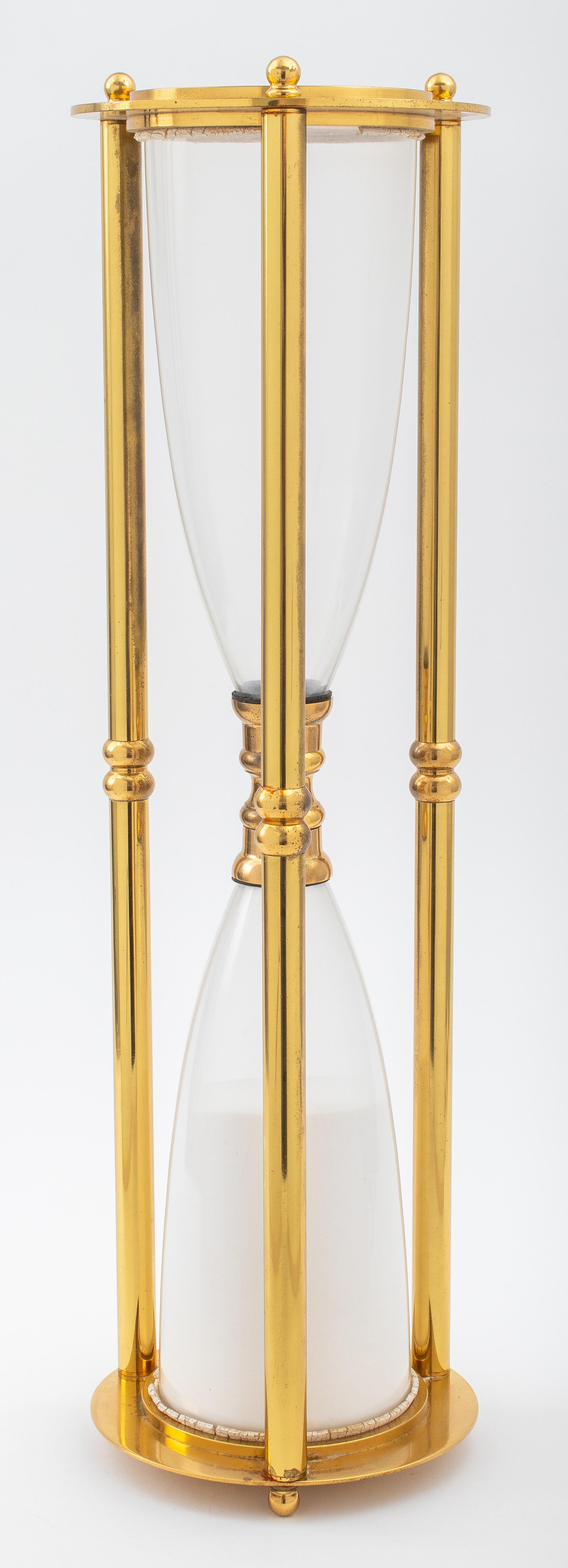 Modern large brass white sand hourglass / timer, unmarked. This item is not functional. 
Dimensions: 24.25