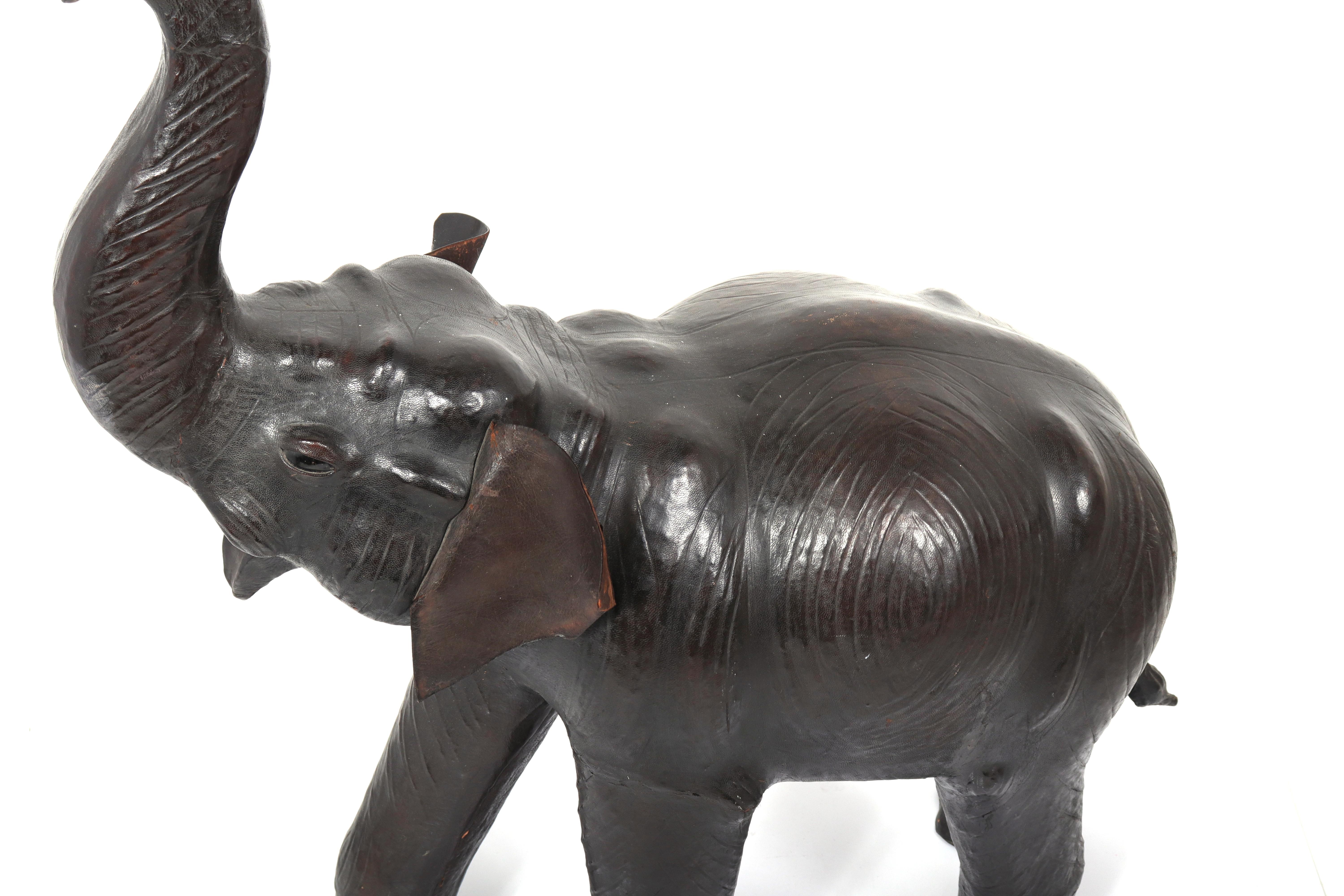 Large modern leather-clad elephant sculpture. The piece is in great vintage condition with minor wear to leather including edges of ears and missing tusks.