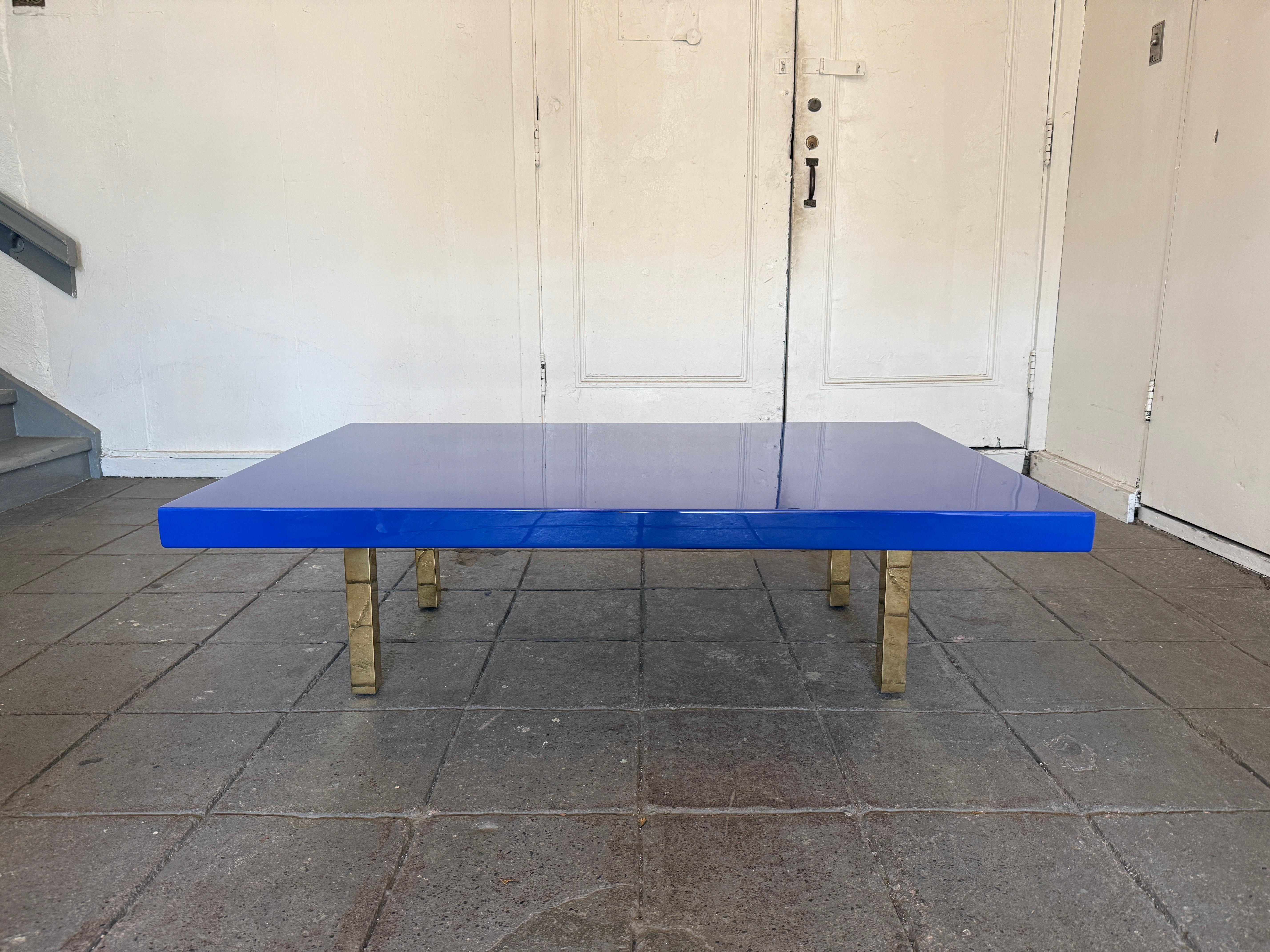 Modern large low bright blue high gloss lacquer coffee table with brass legs. In the style of post modern. Very fun colorful low coffee table. Sits on (4) square tube brass or gold chrome plated legs. Very heavy and sturdy table. Custom made circa