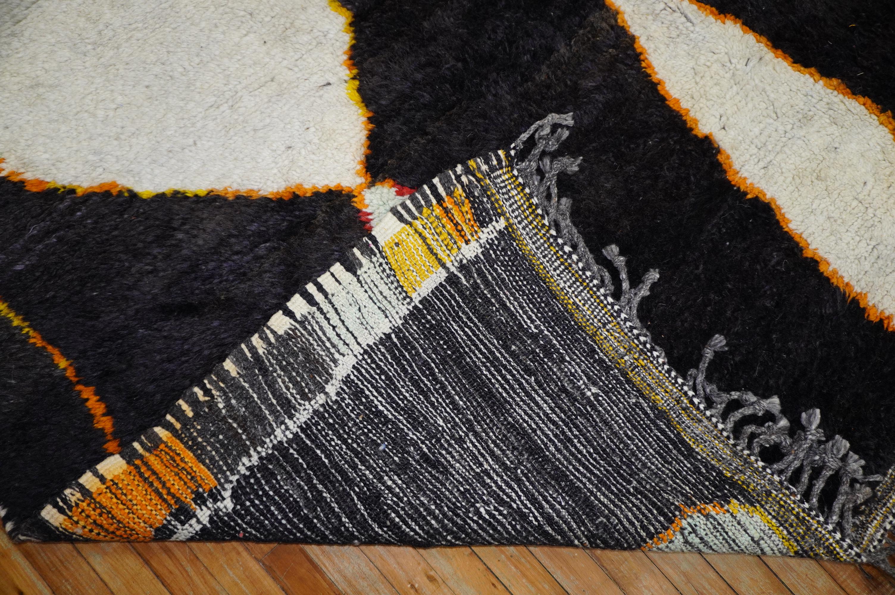 Wild large scale room size modern Moroccan rug featuring electric colored large abstract motifs on a black field. The wool is the best of its kind and 100 % vegetable dyed. This piece is a one of a kind and was handpicked to add to our collection.