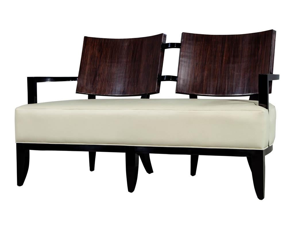 Unique, sleek and modernly designed settee upholstered in a premium Italian taupe Color leather. Featuring a rosewood back rest and Ruhlmann style legs. All finished in a hand polished high gloss finish. Unique design, only one available.