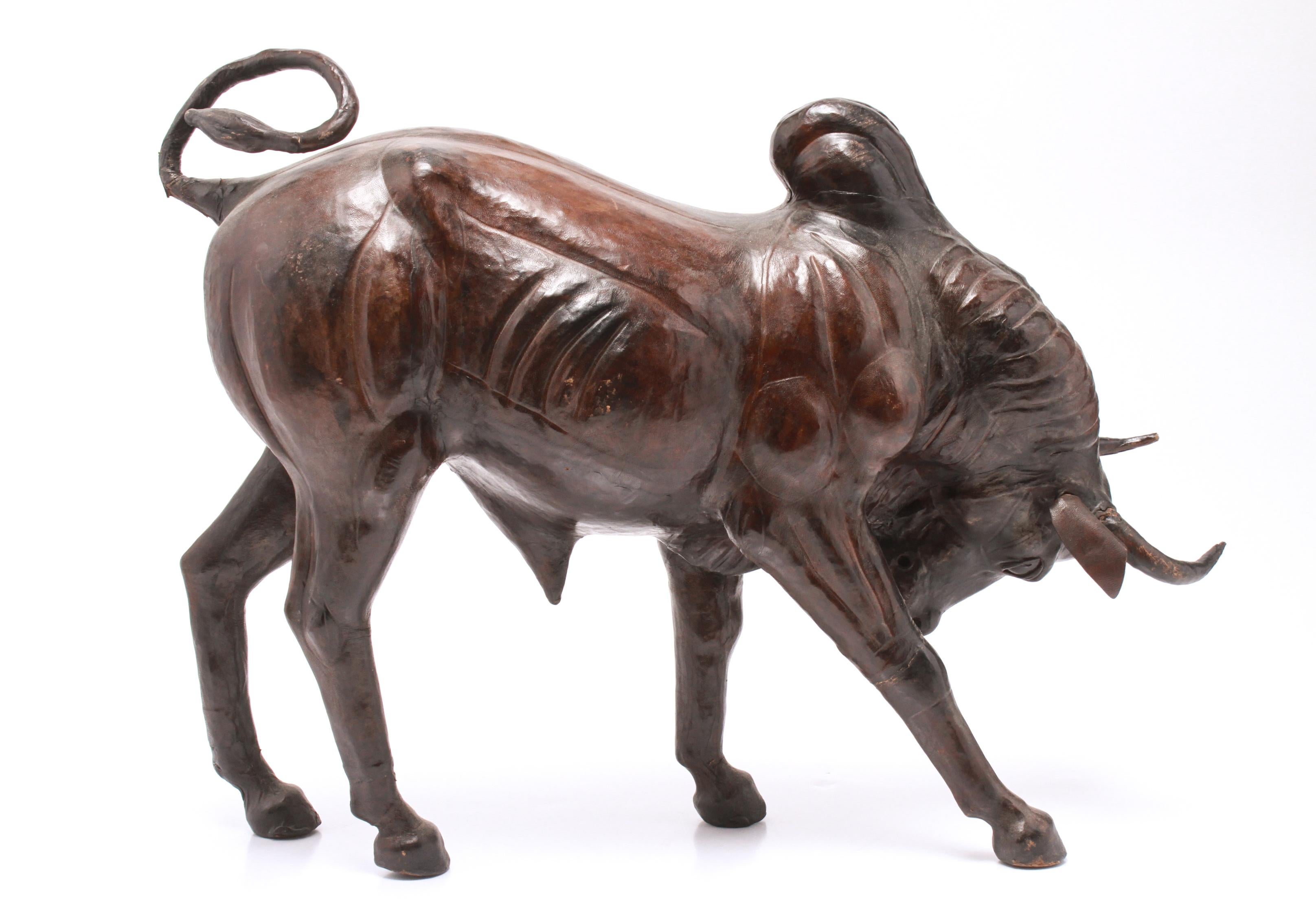 Modern sculpture of a charging Brahma or Brahman bull. The piece is clad in leather and is in great vintage condition with some age cracks in the leather.
