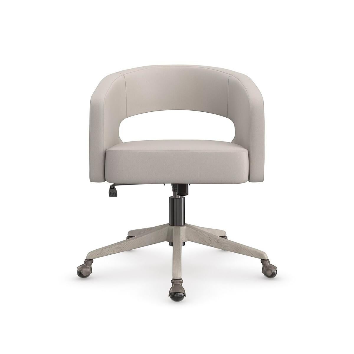 A sophisticated take on the traditional desk chair, with a curved, open back and softly upholstered seat in a supple taupe leather. An exposed ash wood detail on its swivel base adds warmth and a harmonious element. Casters make it easy to move and