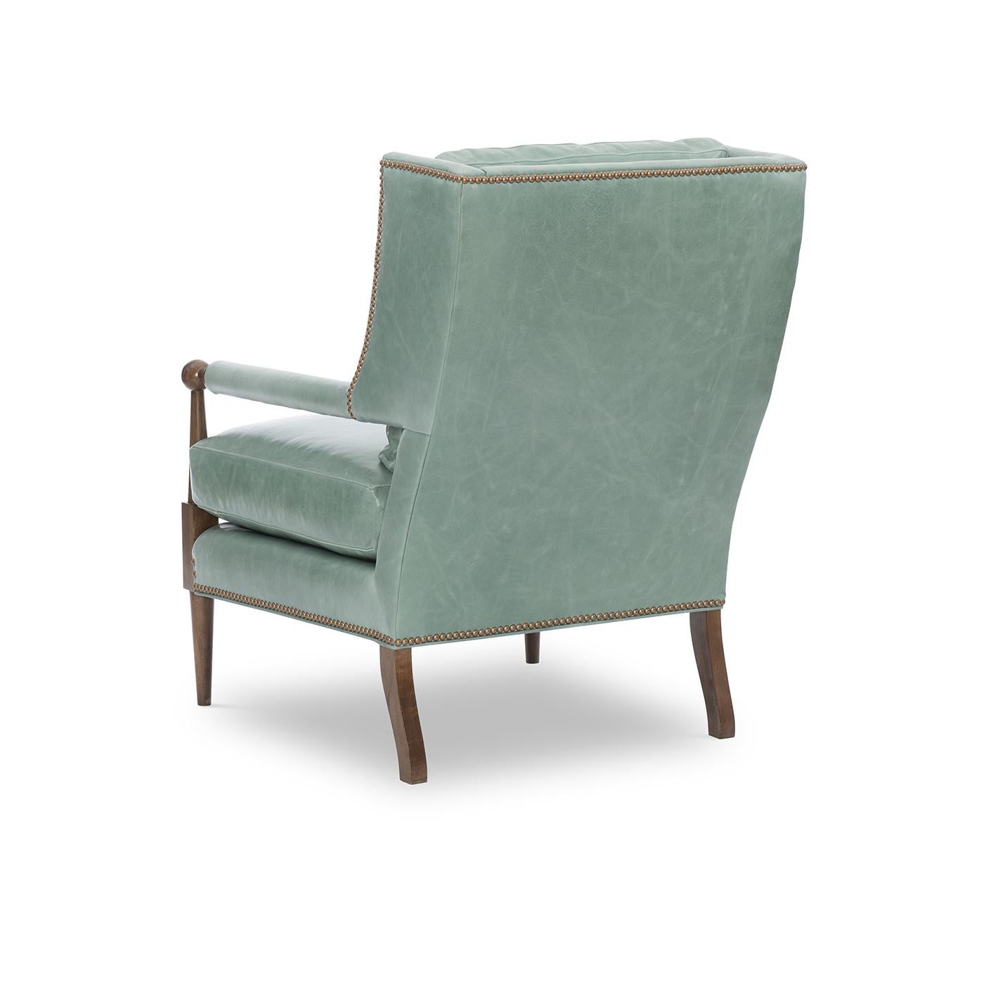A Modern leather upholstered armchair with a combination of classic and modern elements. A loose back pillow and a comfort down seat cushion.

Shown in Mont Blanc Rainforest leather with brass nailhead trim. 

Completely Made in USA, with