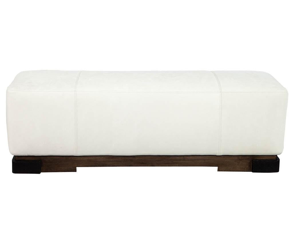 Modern leather ottoman by Kara Mann. Classic modern style with a walnut base designed by Kara Mann for Baker Milling Road. Minor markings on leather, sold as is at an incredible price.
Price includes complimentary curb side delivery to the
