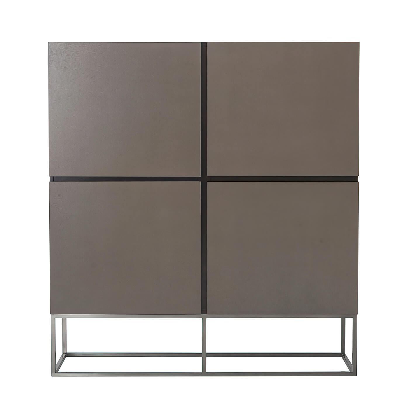 A modern leather paneled four-door cabinet, with an ossian finish cherry case, eclipse leather-wrapped panel doors with four sections having adjustable shelves, and raised on a boxed gunmetal finish steel base.

Dimensions: 57