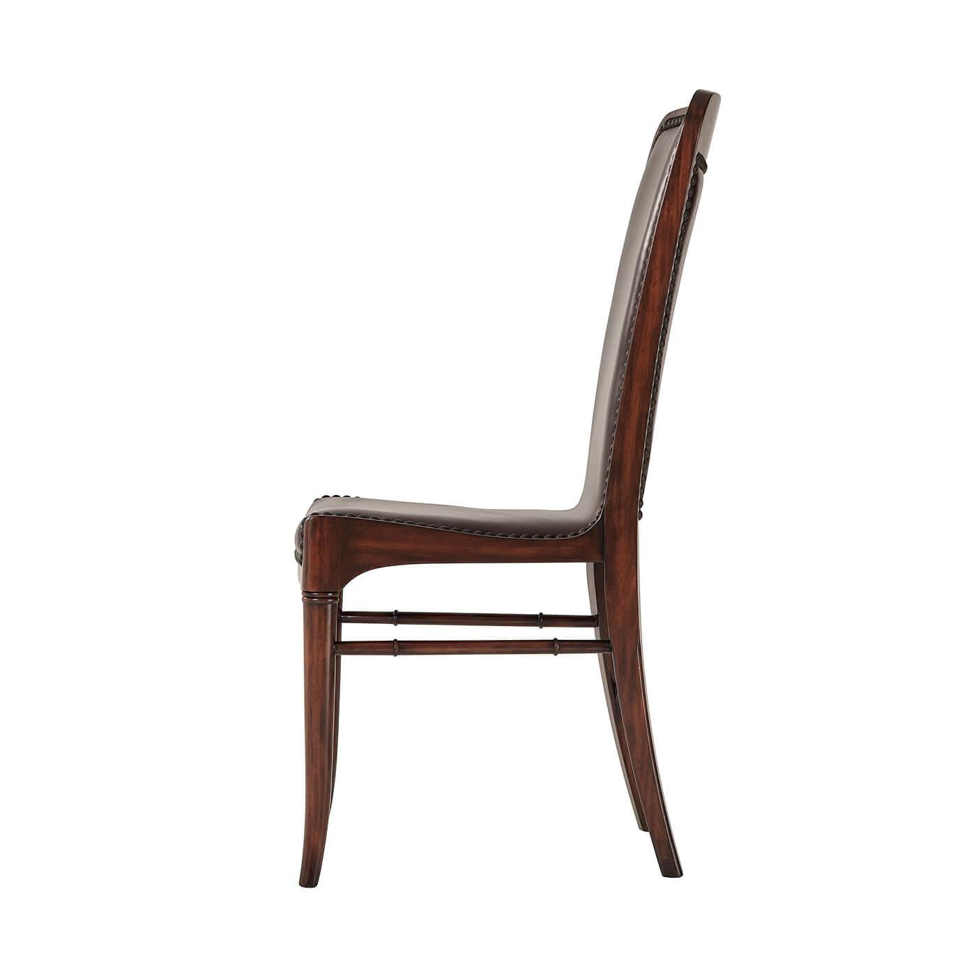 A modern leather upholstered side chair, the upholstered sling back and seat with nailhead decoration, on turned and splayed legs. Upholstered in Old English Leather. 

Dimensions: 19.75