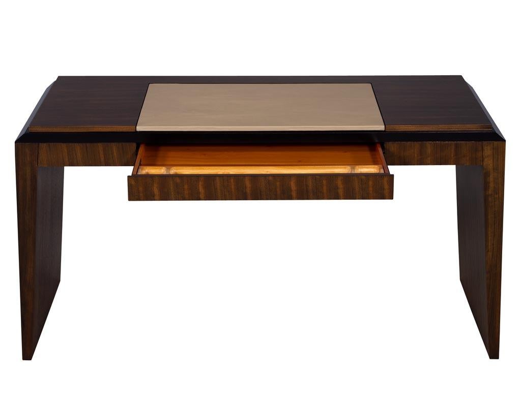 Modern leather top desk in zebra wood. Zebra wood splayed sided designed desk with a taupe leather top. Desk sports a convenient center pencil drawer. Perfect for a sleek home office setting.

Price includes complimentary scheduled curb side