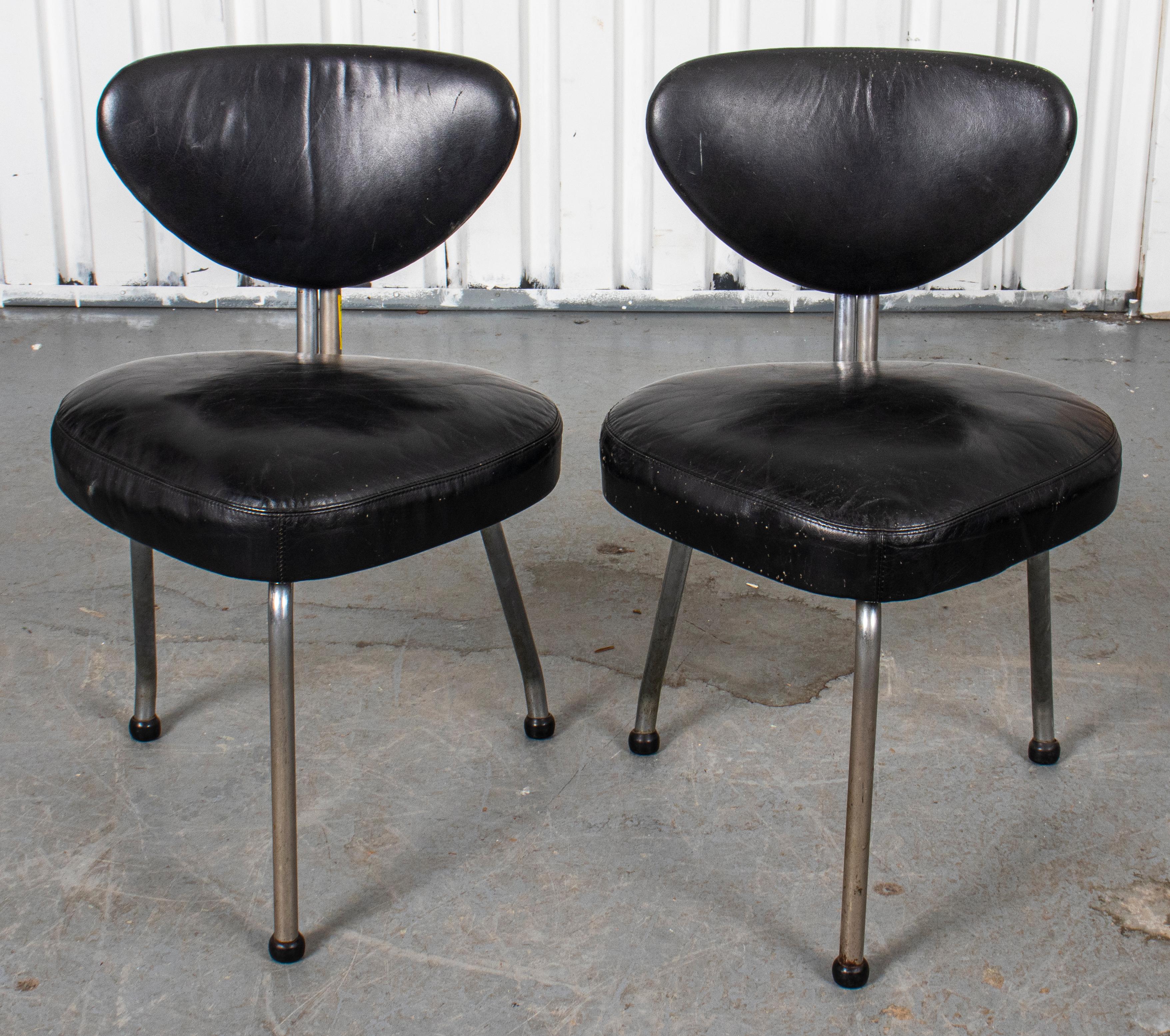 Pair of black leather upholstered side chairs with aluminum frame. Measures: 30.5” H x 20” W x 18.5” D.
 