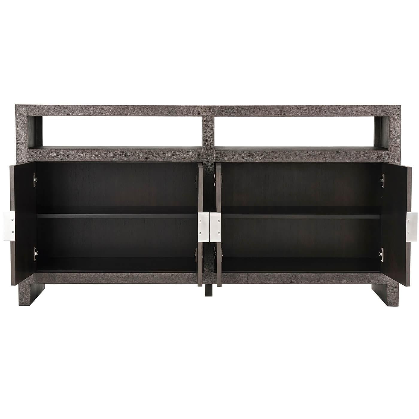 Modern shagreen embossed leather-wrapped buffet with our dark tempest finish leather with a rectangular top with two open shelves and four cabinet doors with inlaid metal handles.
Dimensions: 68