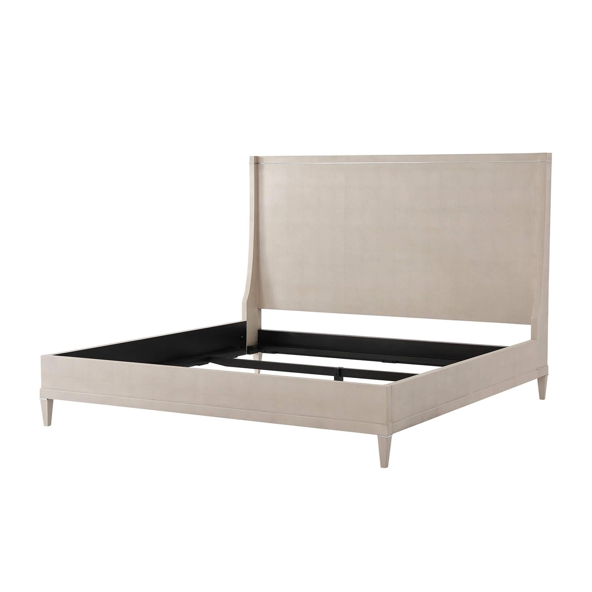 A modern embossed leather wrapped king size bed with a winged end headboard, polished nickel molding detail inlays and a stepped rail frame with square tapered legs.
Dimensions: 80.75