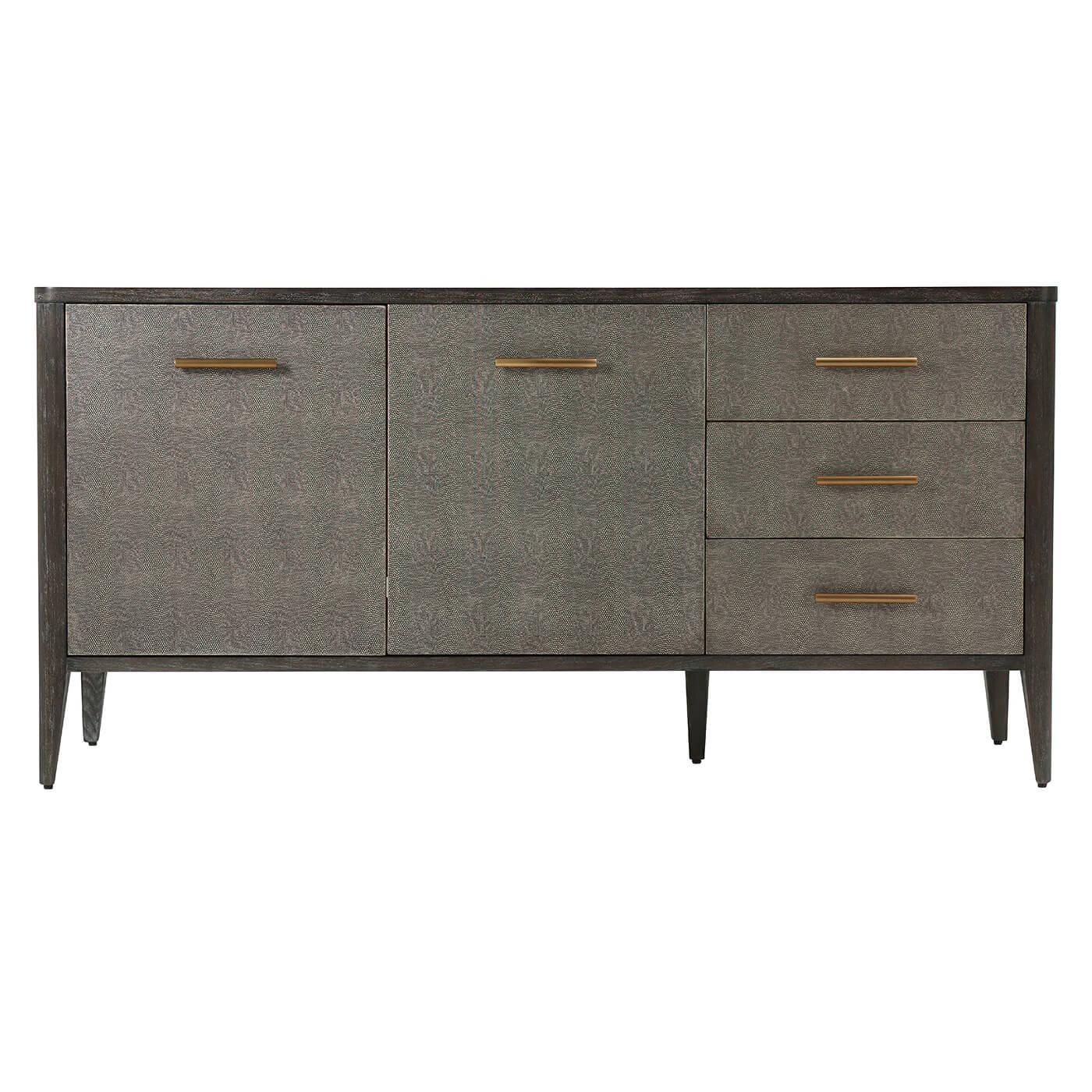 Midcentury style dark tempest embossed leather wrapped sideboard with rowan finish primavera veneer and beech with three drawers beside a two-door cabinet enclosing adjustable shelved and with brushed brass finish handles.

Dimensions: 66.5