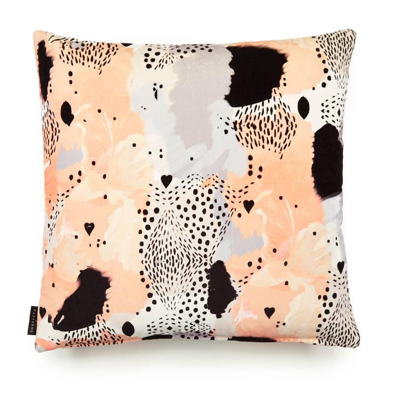 Love leopard peach cotton velvet cushion by 17 Patterns (London, UK) a beautiful exploration into the wild. Using traditional and digital mark-making techniques, this alluring composition of love hearts, spot formations and peppered textured