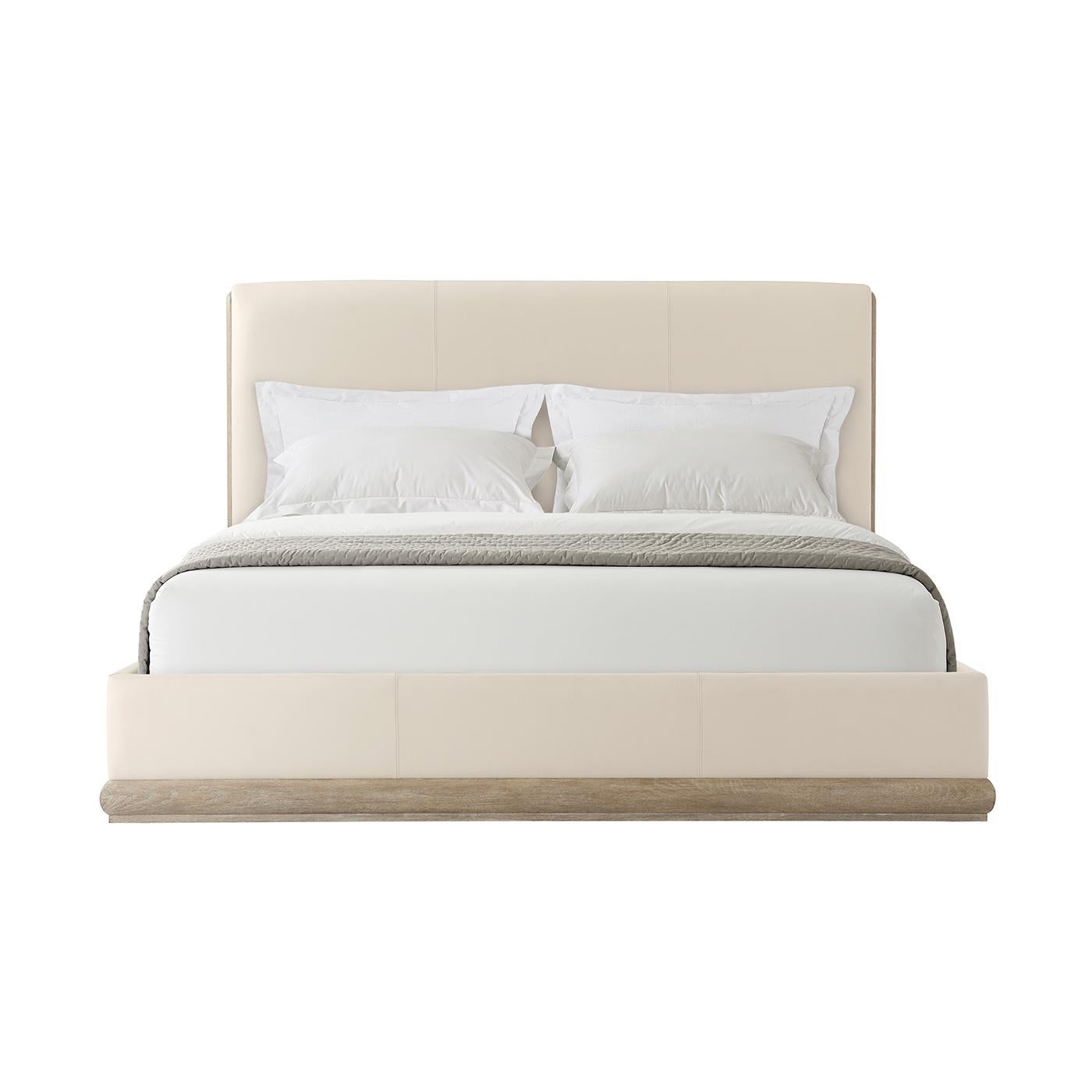 Oak and Leather Upholstered Bed, nestled in an exposed wood base while the headboard and bottom rails are neatly upholstered. With a light grey oak finished frame, clean lines, soft corners, and a neutral finish, we invite you for a good night’s