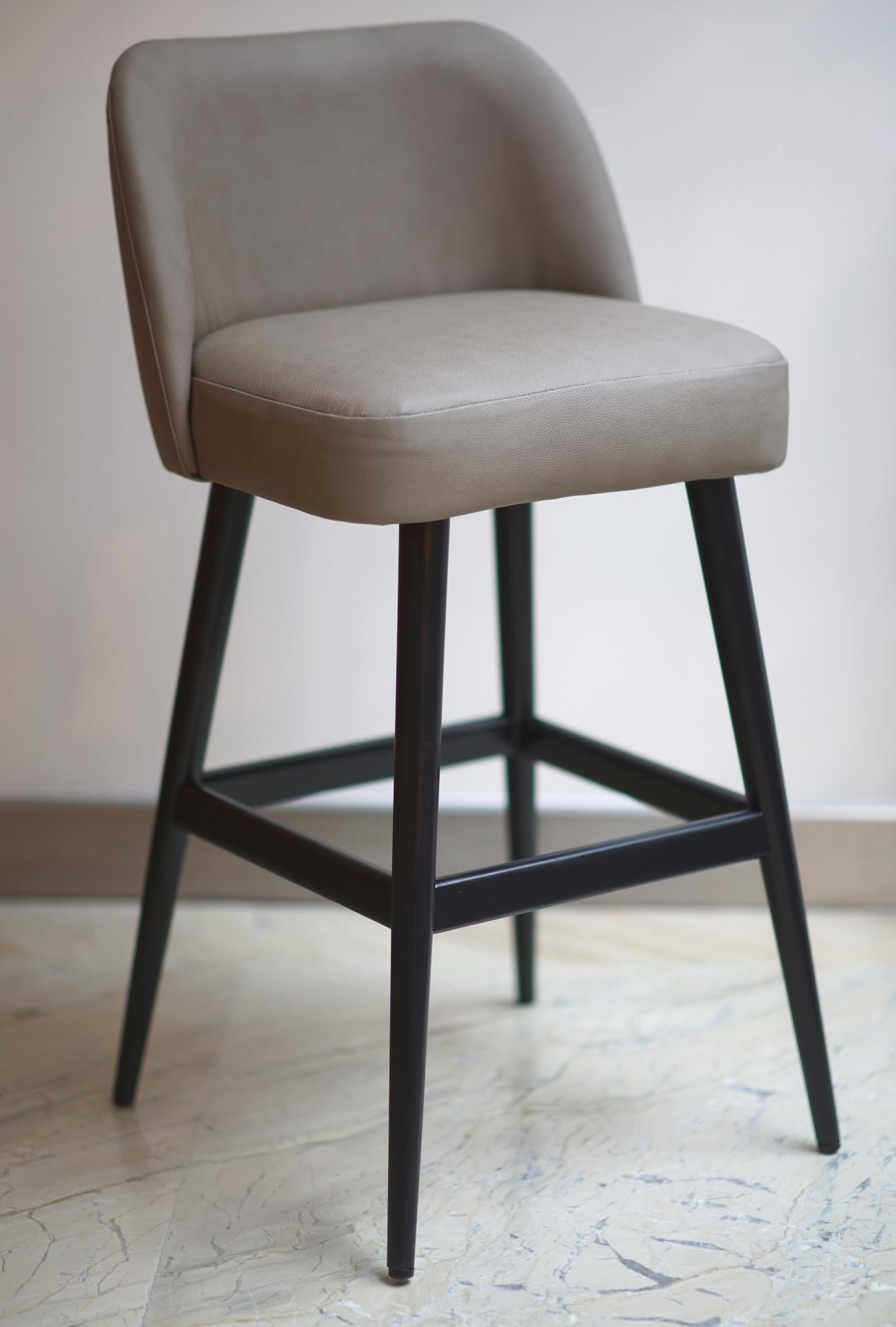 Helsinki collection. Helsinki counter stool: simple, elegant, comfortable. Available in oak and walnut base or in custom materials, may be upholstered with variety of fabrics and colors. Natural leather and Vegan Leather option available. Also