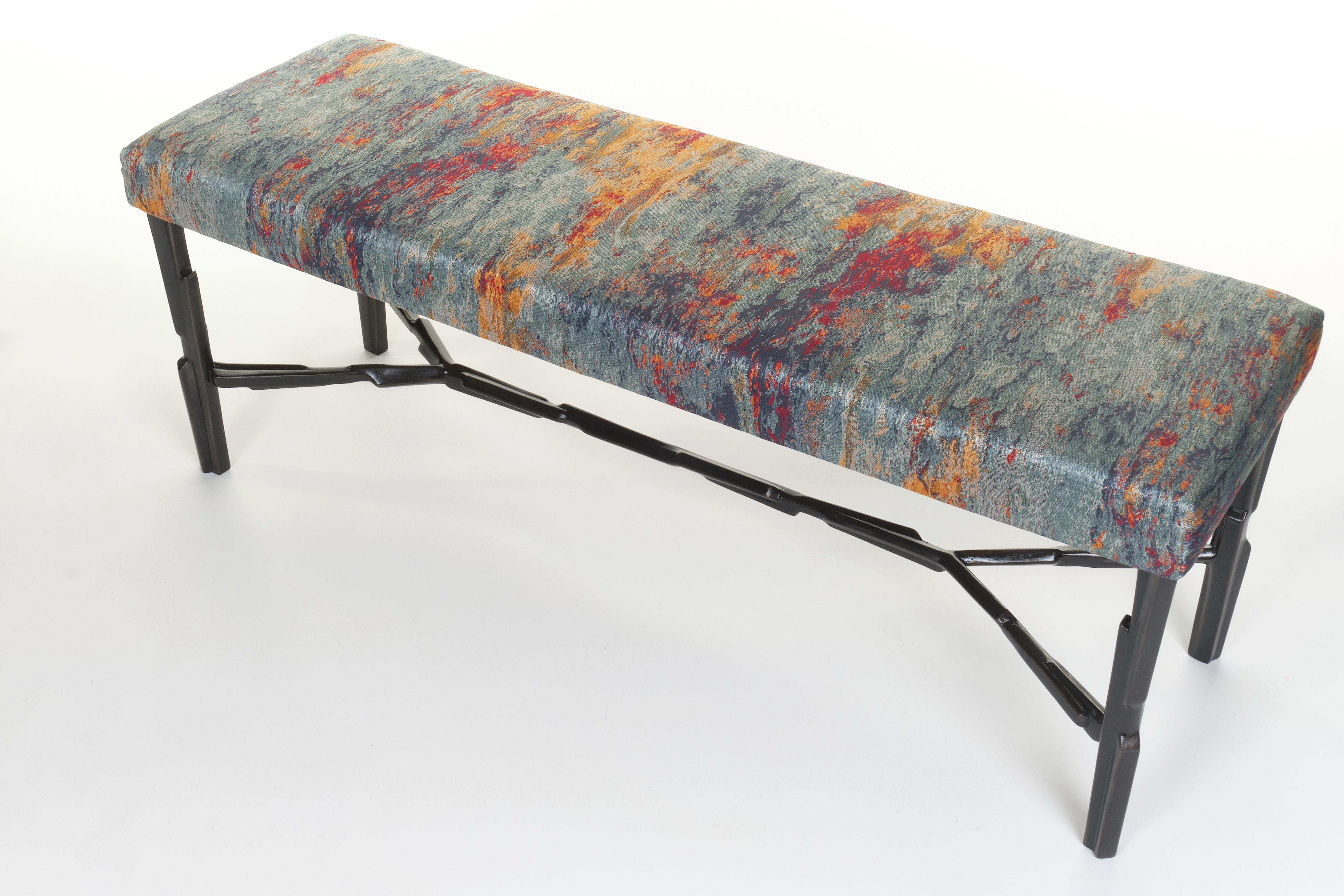 Linea bench is characterised by a hand-worked feet finished in bronzed plaster with an upholstered seat pad available in a range of ten jacquard fabrics from the ,,Second Firing” series, designed by Peter Marino for Rubelli. These unique of their