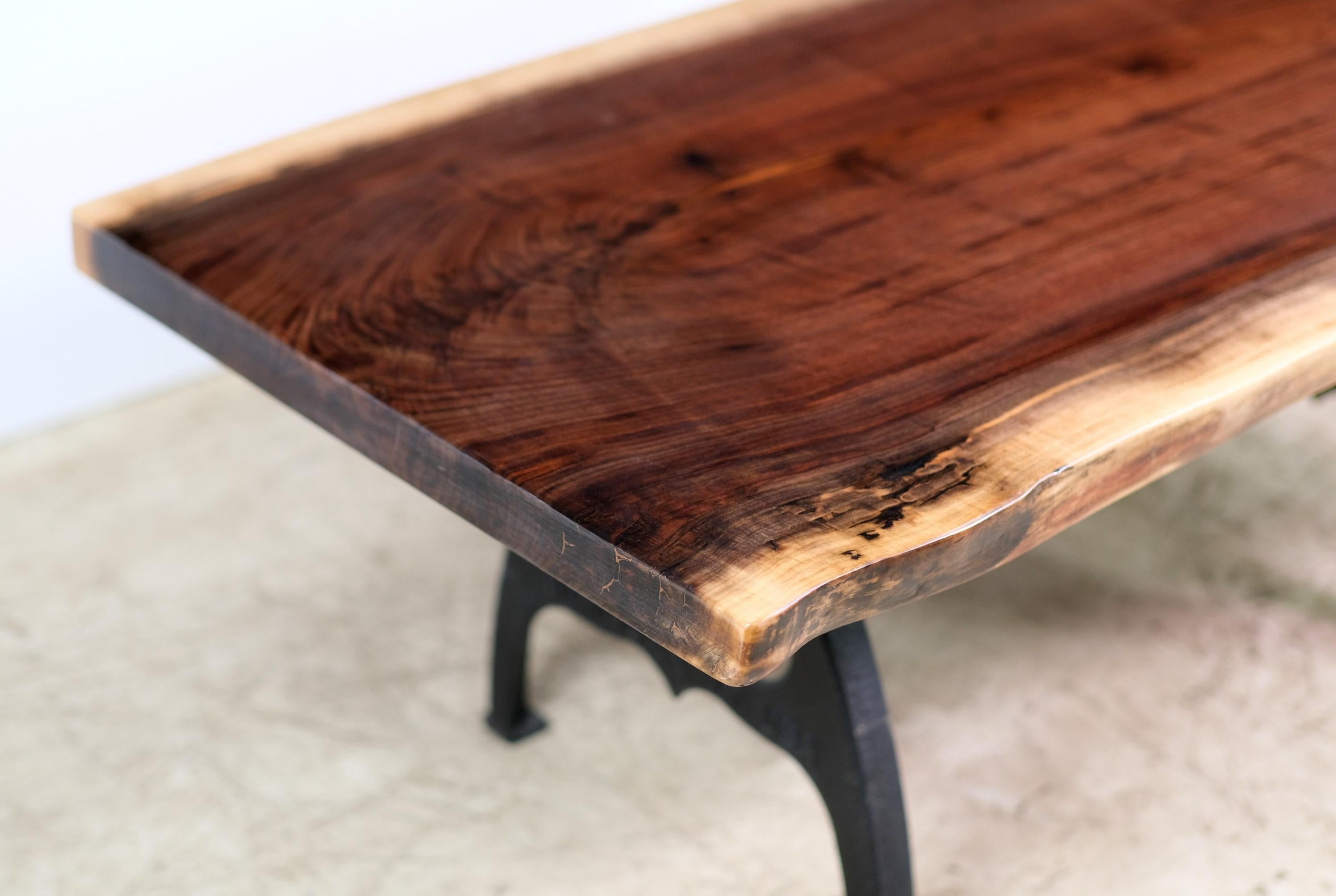 Hand made live edge table made out of a single piece of reclaimed walnut. Comes complete with a pair of Industrial style cast iron legs. This can be seen at our 2420 Broadway location on the upper west side in Manhattan.