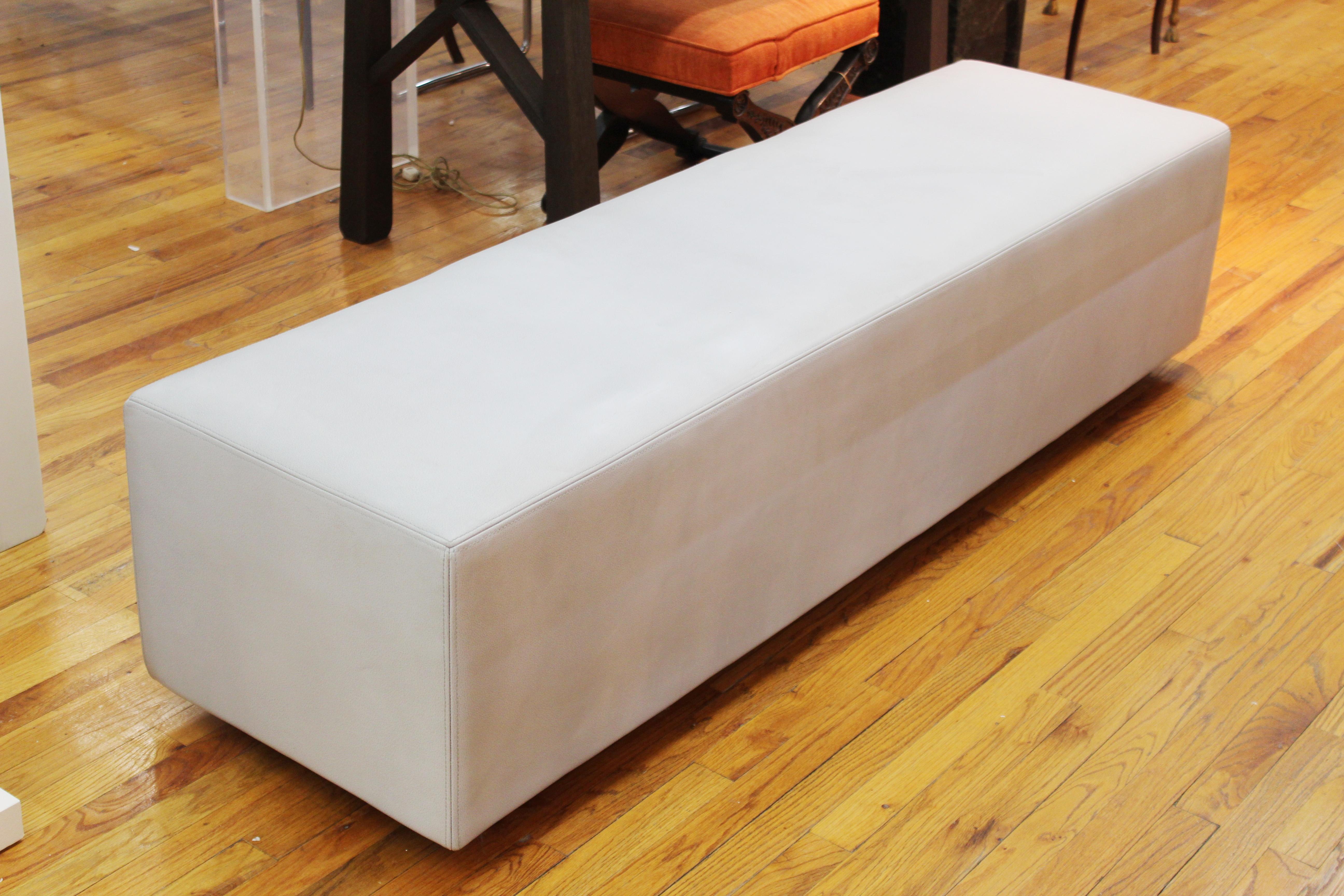 Modern long stretched rectangular bench attributed to Christian Liaigre. The piece is upholstered in pale blue leather. In great vintage condition with age-appropriate wear and use.