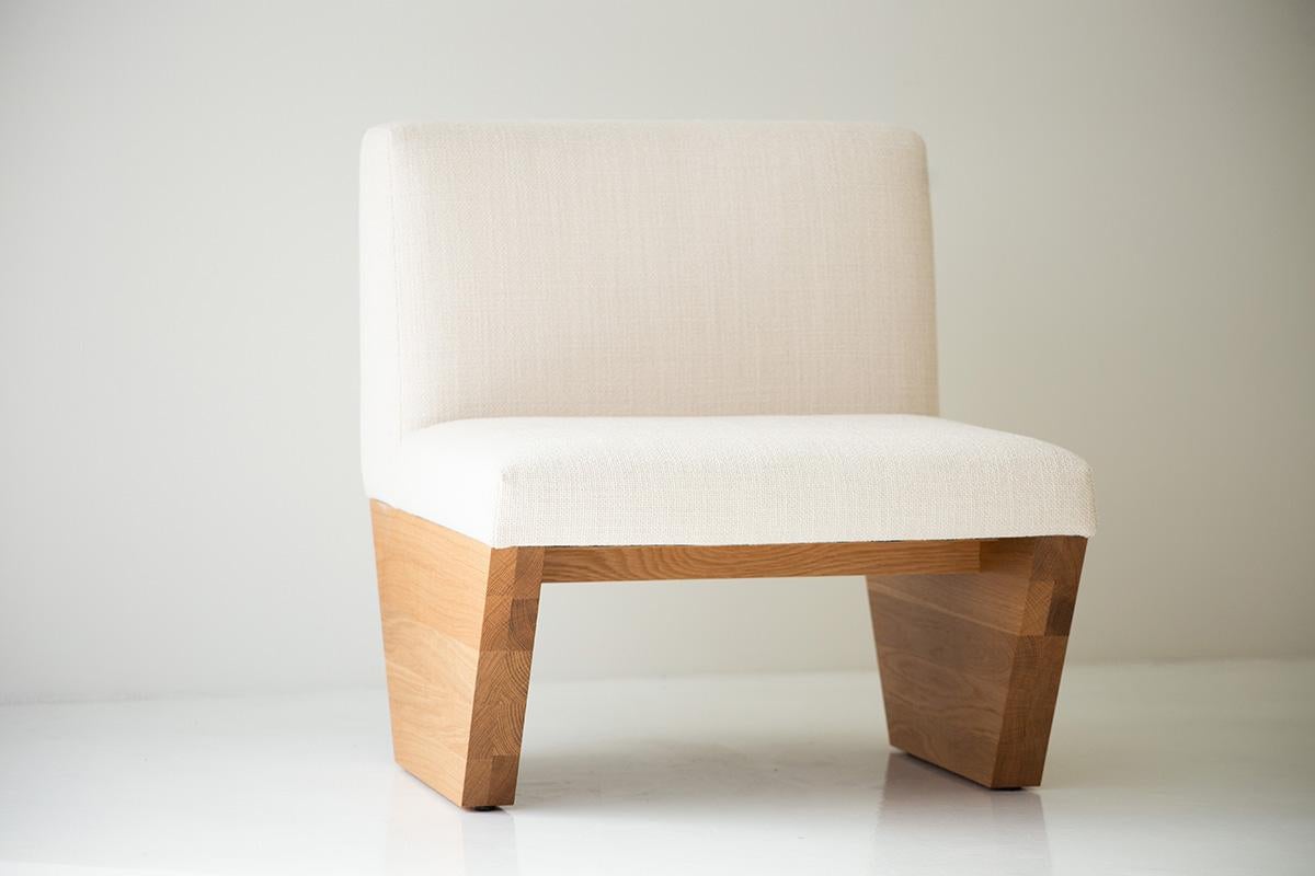 This Modern Lotus Side Chair in White Oak is beautifully constructed from solid wood in Ohio, USA. The side chair's silhouette is modern, architectural, and yet simple with comfortable back and seat cushions. Perfect for any space that needs a
