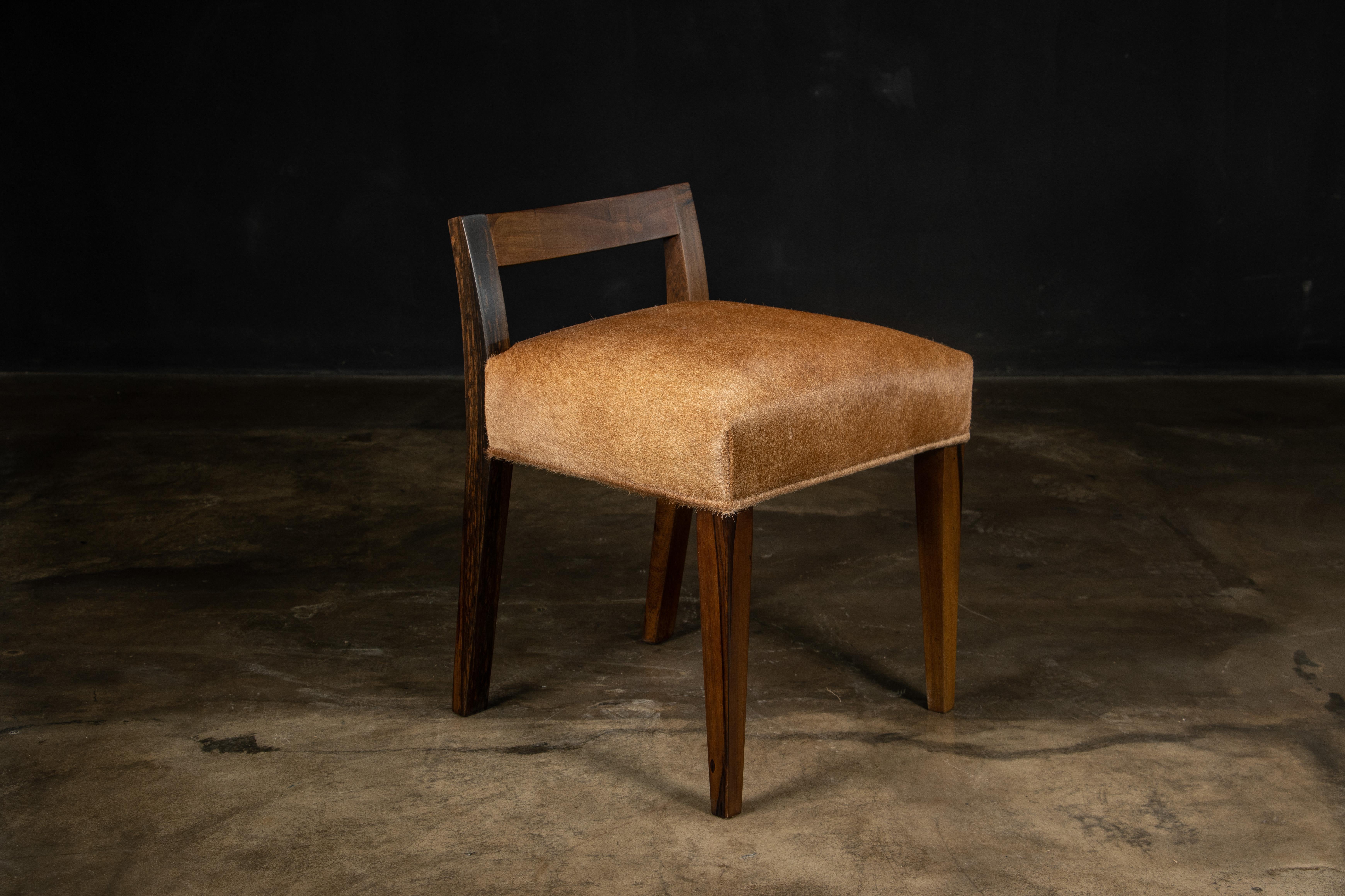 Umberto Modern Low Dining Chair in Sustainably Sourced Exotic Argentine Rosewood & Hair Hide from Costantini Design 

The Umberto Chair is one of Costantini’s original seating designs, featuring a modern, low, carved solid wood back with a tight