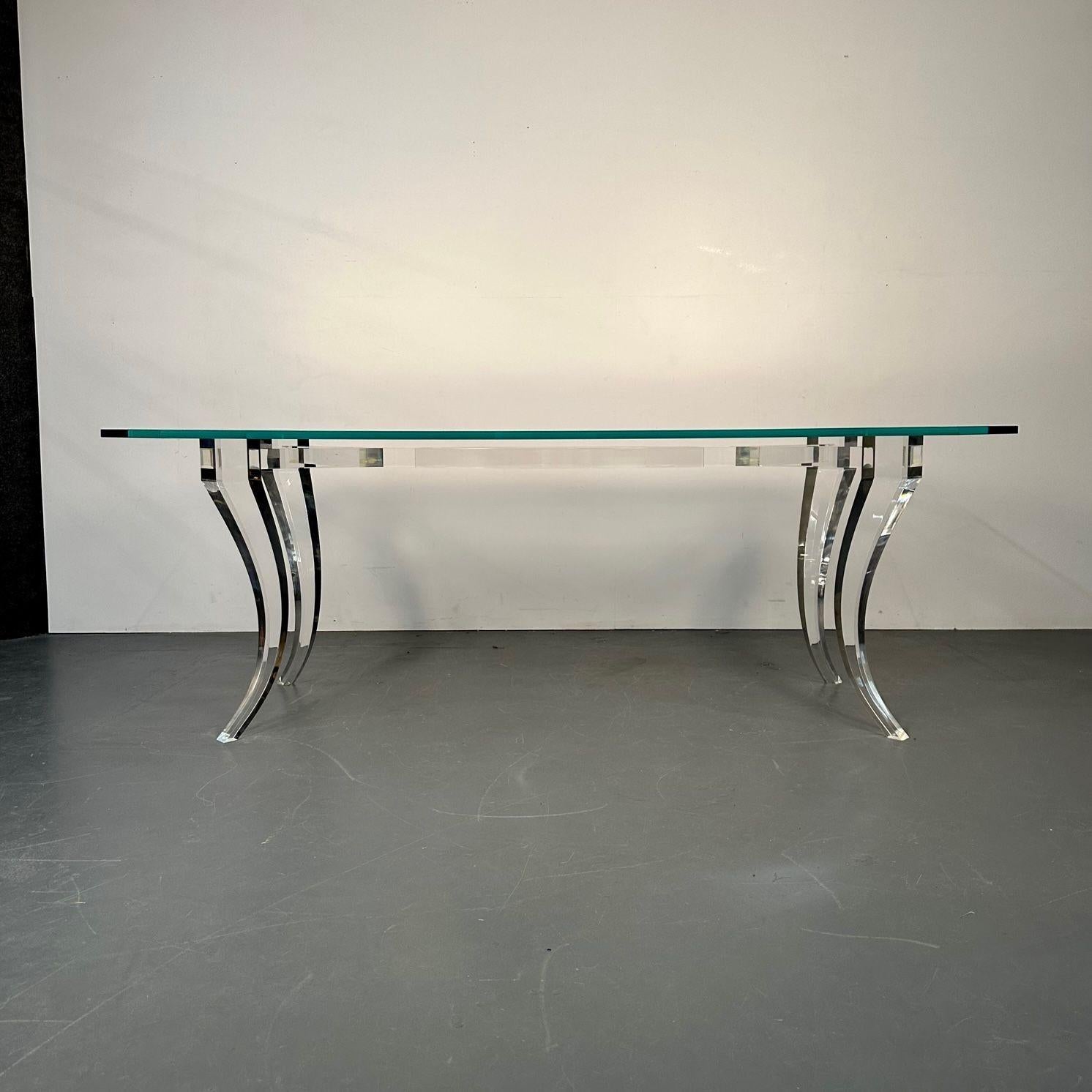 Modern Lucite and glass dining / kitchen table, center table, American Designer, 2000s
This strong and sturdy dining table is sleek and stylish having a thick Lucite base with curved legs leading to a bow top supporting a thick glass table top.