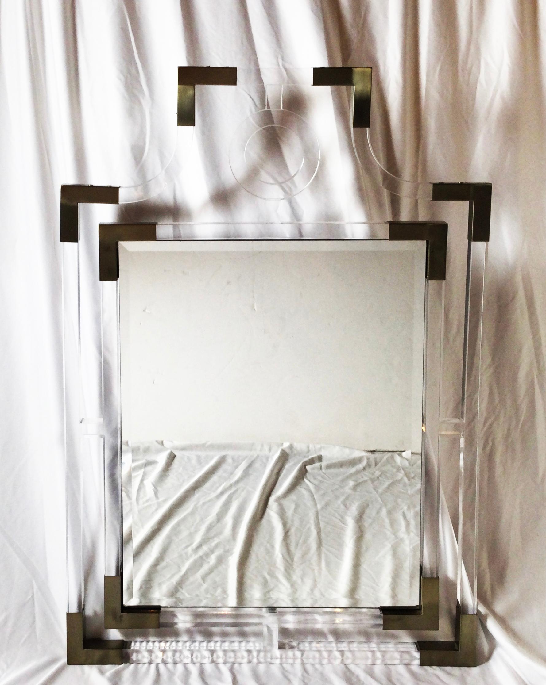 Stylish modern lucite and metal wall mirror with beveled mirror. Mesures: 27 by 38