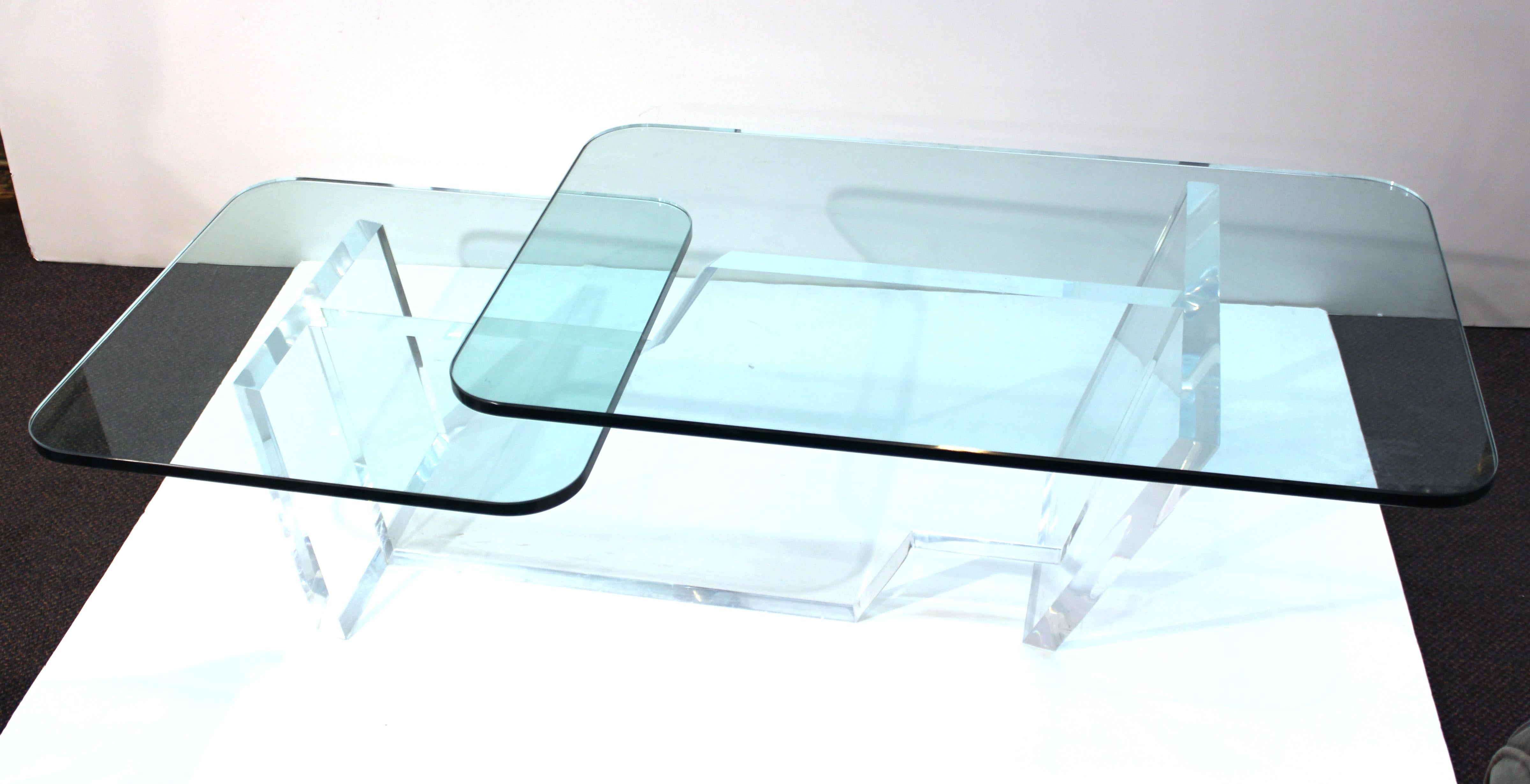 Modern split-level coffee or cocktail table with a thick Lucite base and two levels of glass tops. The piece was made during the mid-to late 20th century and is in great vintage condition with age-appropriate wear.