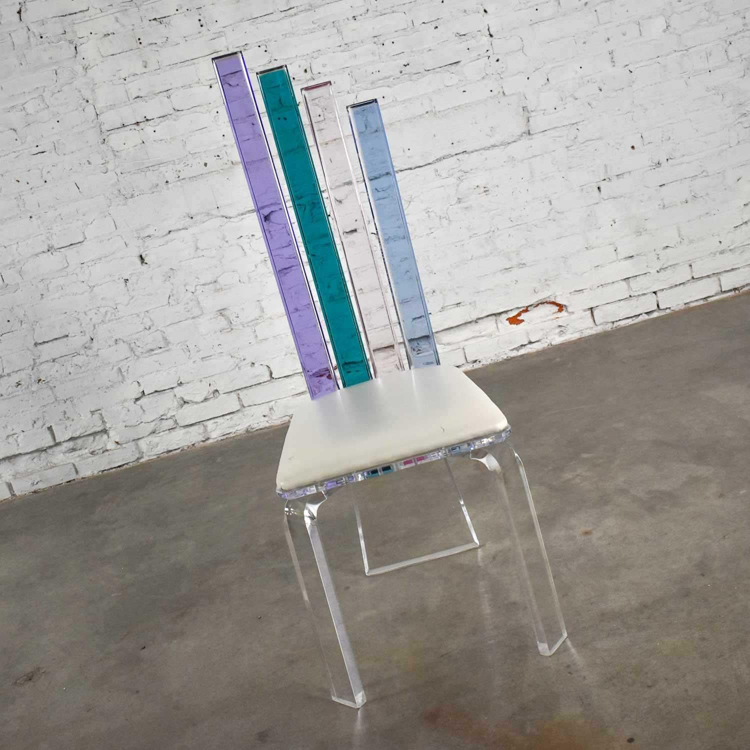 Wonderful modern Lucite chair attributed to Shlomi Haziza for H. Studio with graduating back slats in colors of transparent lavender, teal, pink, and blue with original off-white vinyl upholstery. Gorgeous condition with minor wear as you would