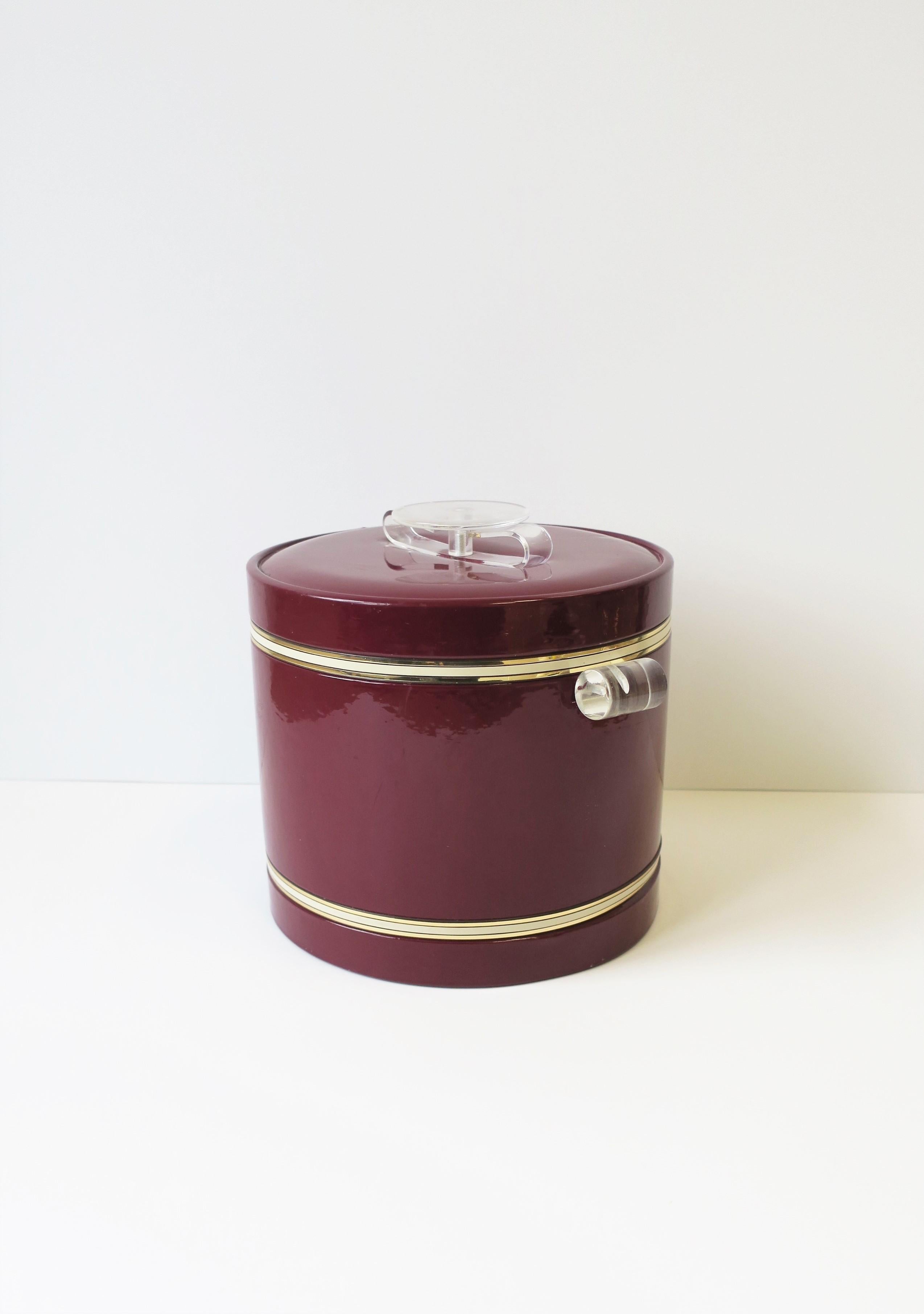 A chic 1960s - 1970s modern red burgundy and clear Lucite ice bucket. This ice bucket can hold some ice, which is nice; it's slightly larger then the typical size ice bucket, 1