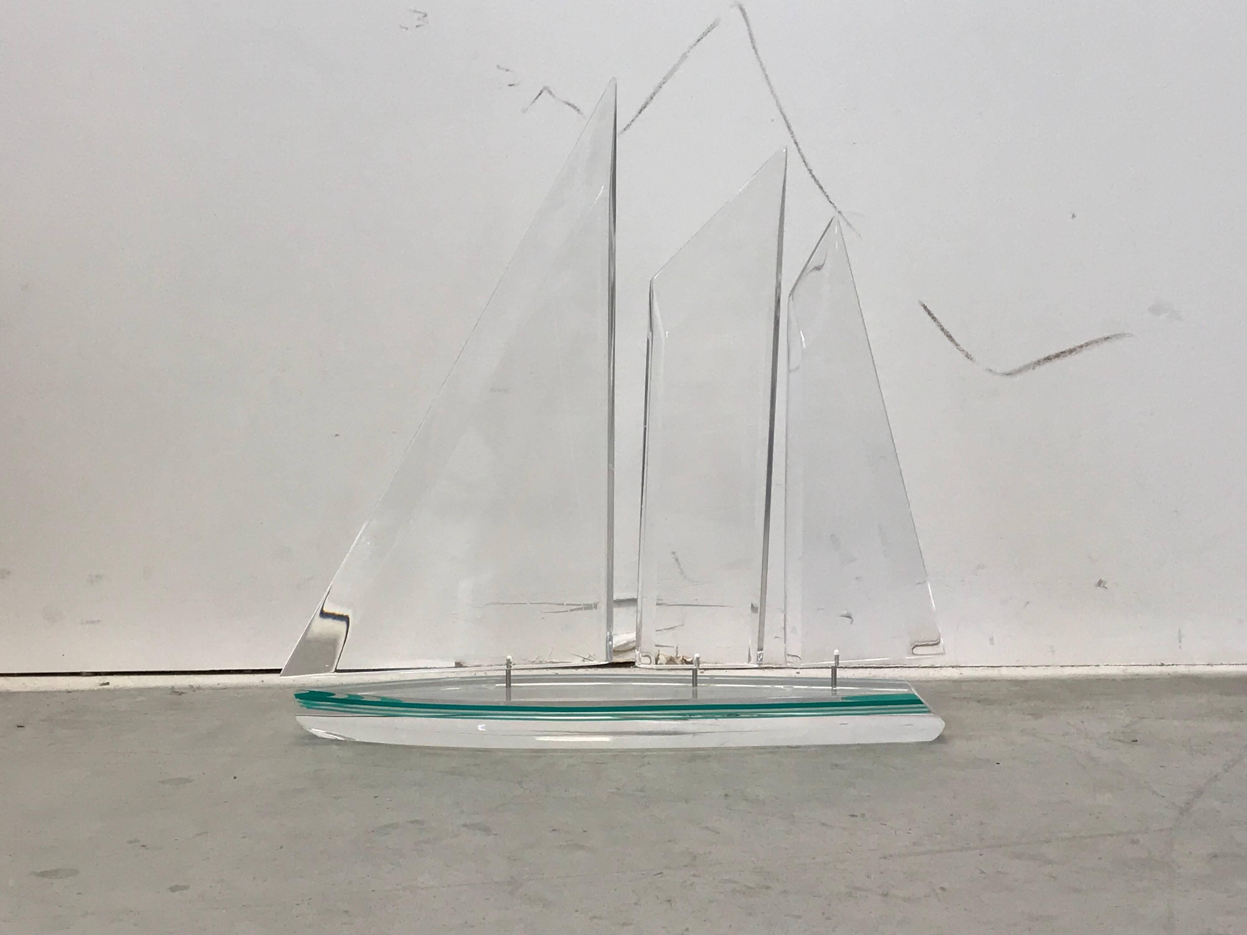 Listed is a stunning, modern Lucite sailboat sculpture. The piece is heavy and very well made — not fragile at all! Note the attention to detail in the sails and pinstriping along the sides of the boat. Signed and dated, 1996. Signature is illegible.