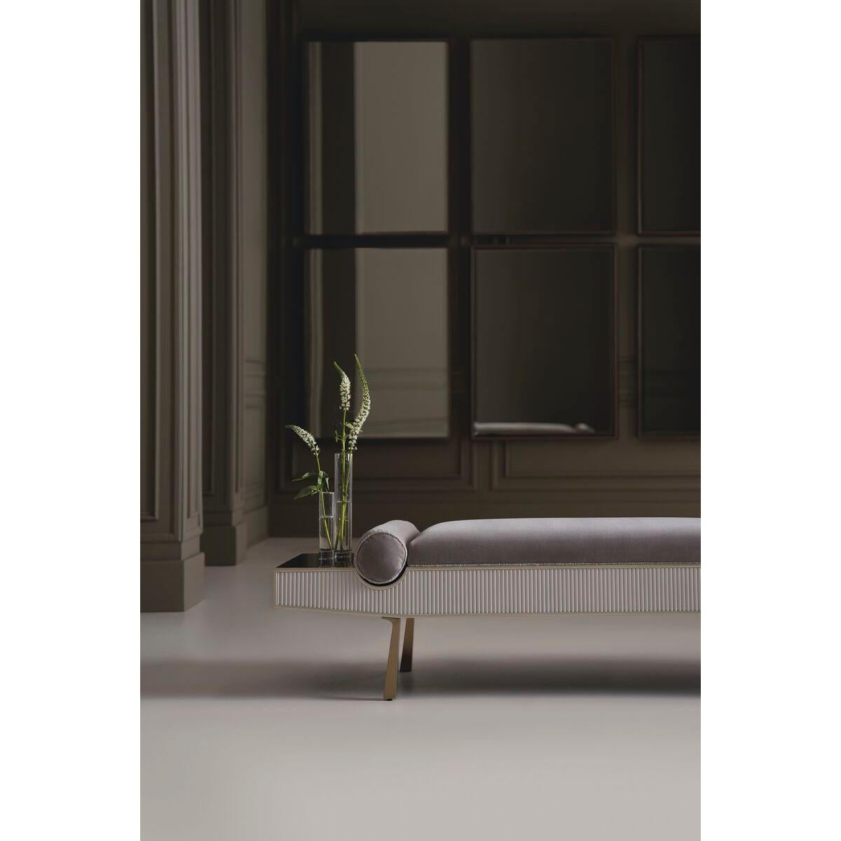 Elegant in a luxe material mix, this streamlined bench is well-scaled for the end-of-bed or an entryway.

A reeded apron in a creamy Almond Milk finish brings a sense of rhythm and striking pattern, complemented by a soft gray mohair fabric with a