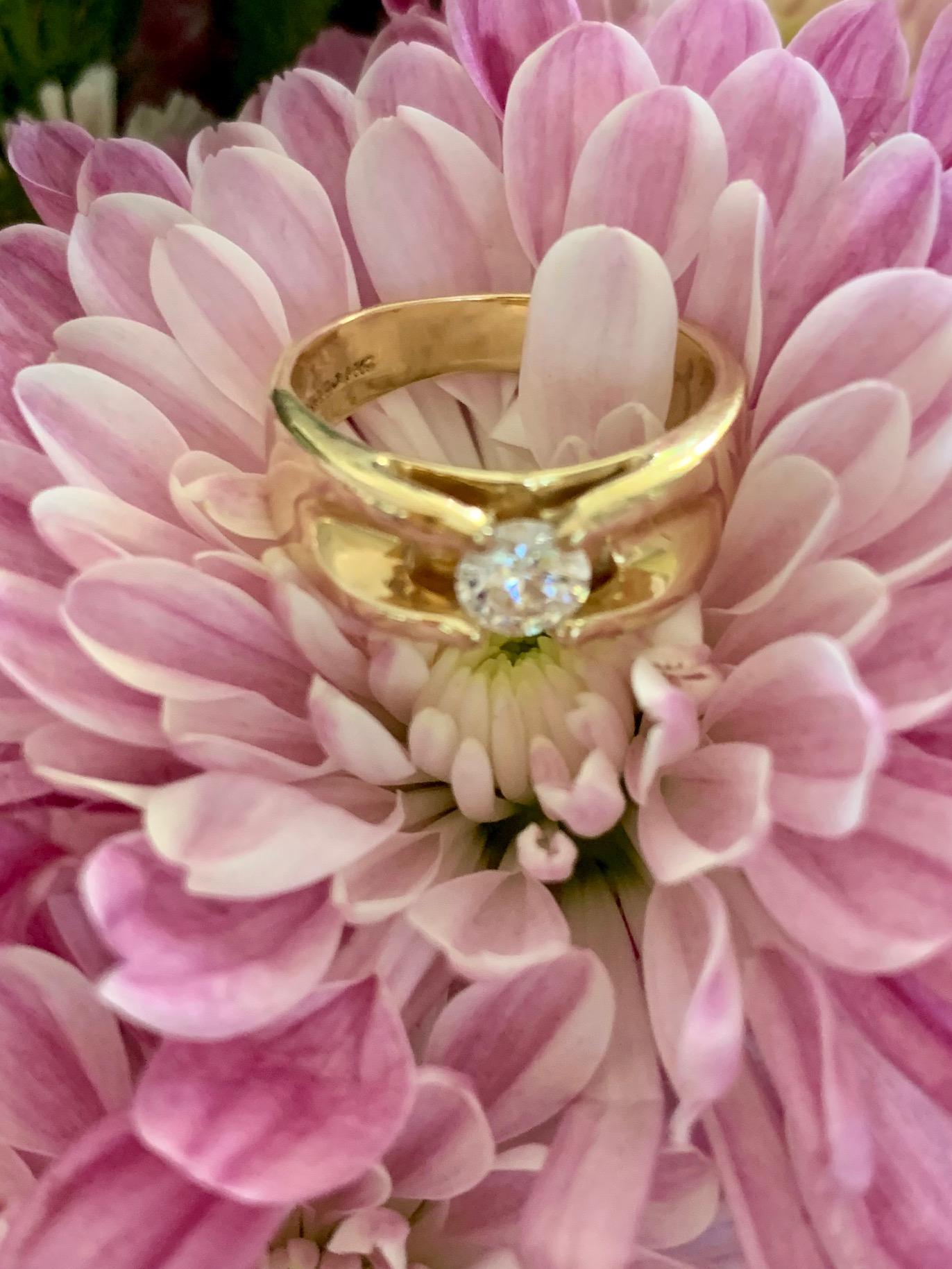 This classic Magic-glo diamond wedding band is made of solid 14k yellow gold and has a comfort fit so it's thick, smooth and has beveled edges.

The ring is a modern design and has a high shine polish.

It is stamped 