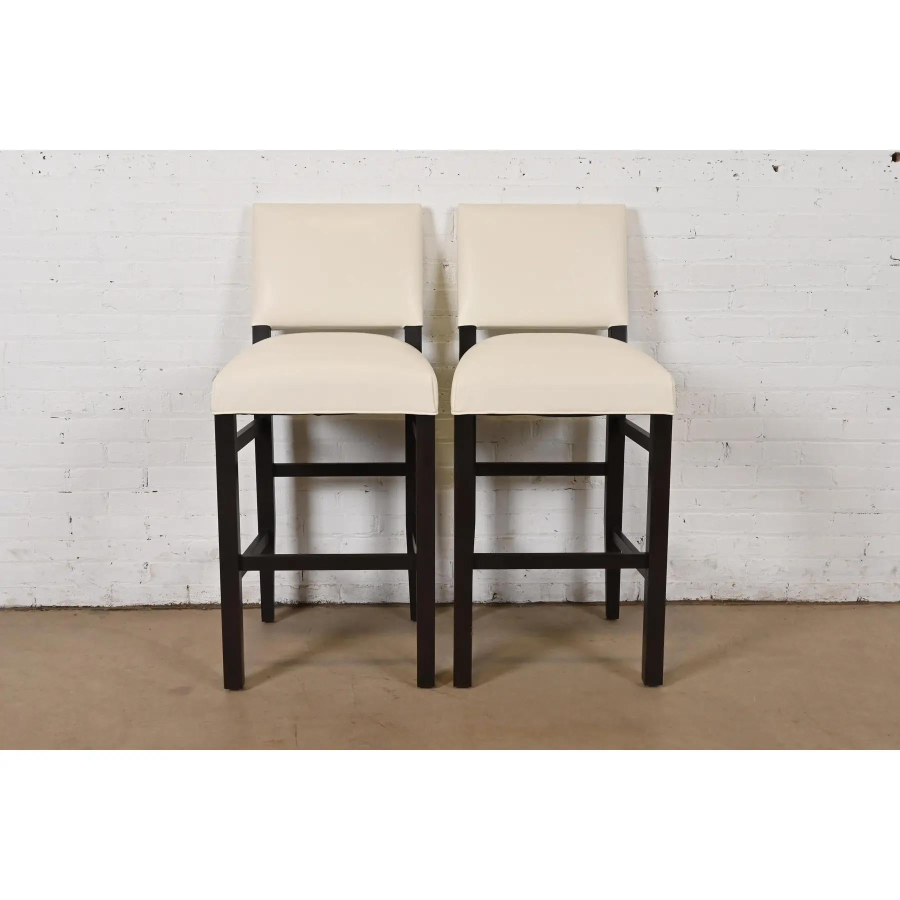 A gorgeous pair of Modern bar stools

In the style of Barbara Barry

USA, Early 21st Century

Dark mahogany frames, with cream leather upholstered seats and backs.

Each measures: 19.5