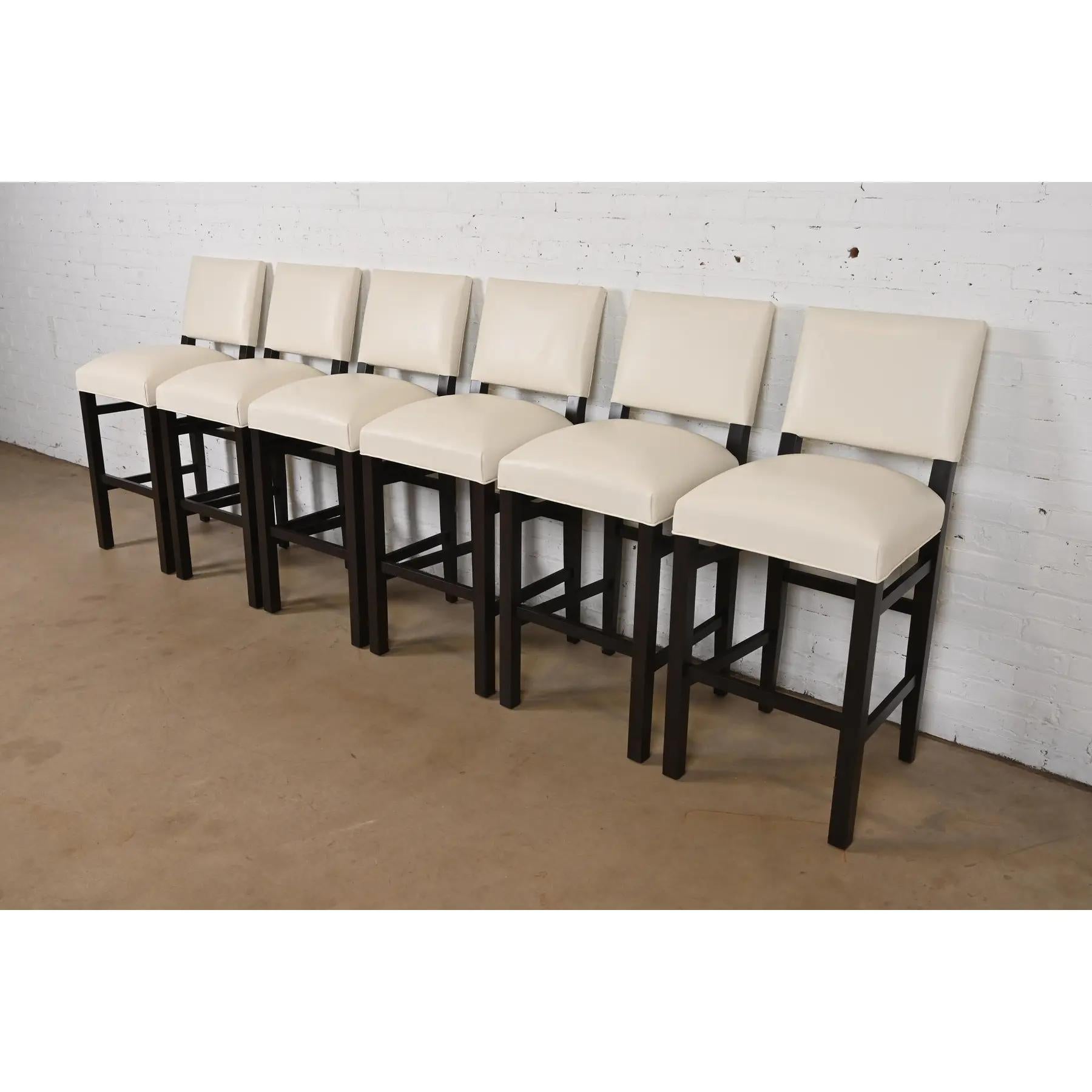 A gorgeous set of Modern bar stools

In the style of Barbara Barry

USA, Early 21st Century

Dark mahogany frames, with cream leather upholstered seats and backs.

Measures: 19.5