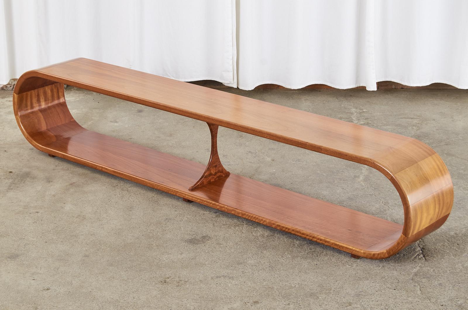 Amazing large modern infinity waterfall cocktail coffee table or long bench seat crafted from mahogany. This one of a kind sculptural oval table is made of thick planks of radiant mahogany with shaped pieces making the round ends. Excellent joinery