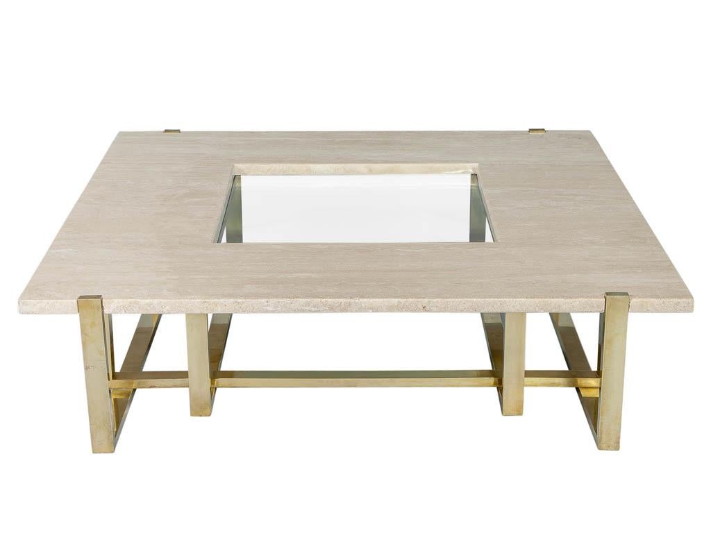 Created for the infamous Maison Jansen by Alfredo Freda, this stunning table will ignite any setting it is placed in. With a rich combination of edgy polished brass, travertine top with a central glass inset, this table epitomizes effortless elegant