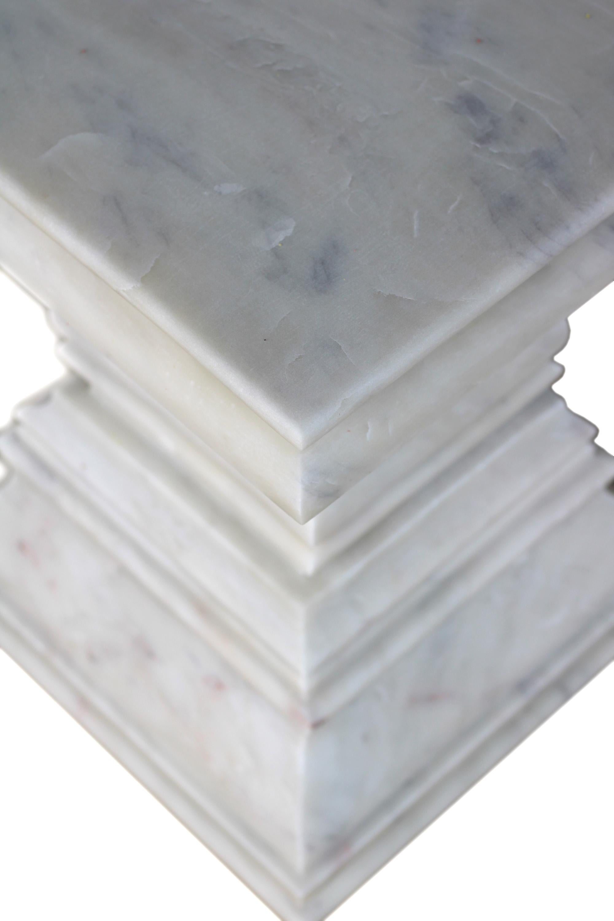 Modern marble pedestal and column side table in white marble by S. Odegard is Inspired by the column capitals of the roman architectural style, this modern marble pedestal and column side table is a statement piece. A sculpture marble pedestal and